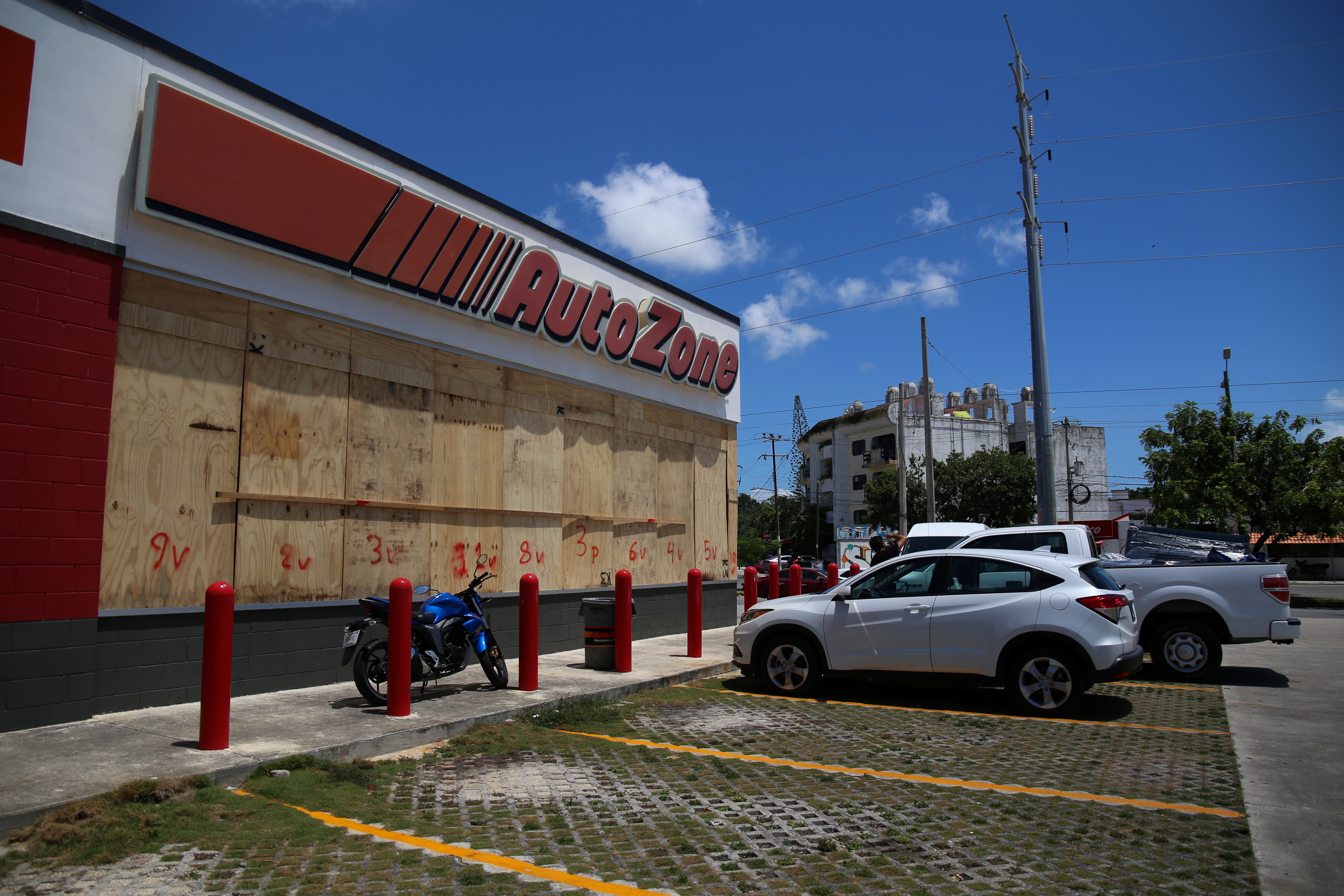 A store is boarded up with plywood in preparation for the arrival of Hurricane Grace in Cancun, Mexico
