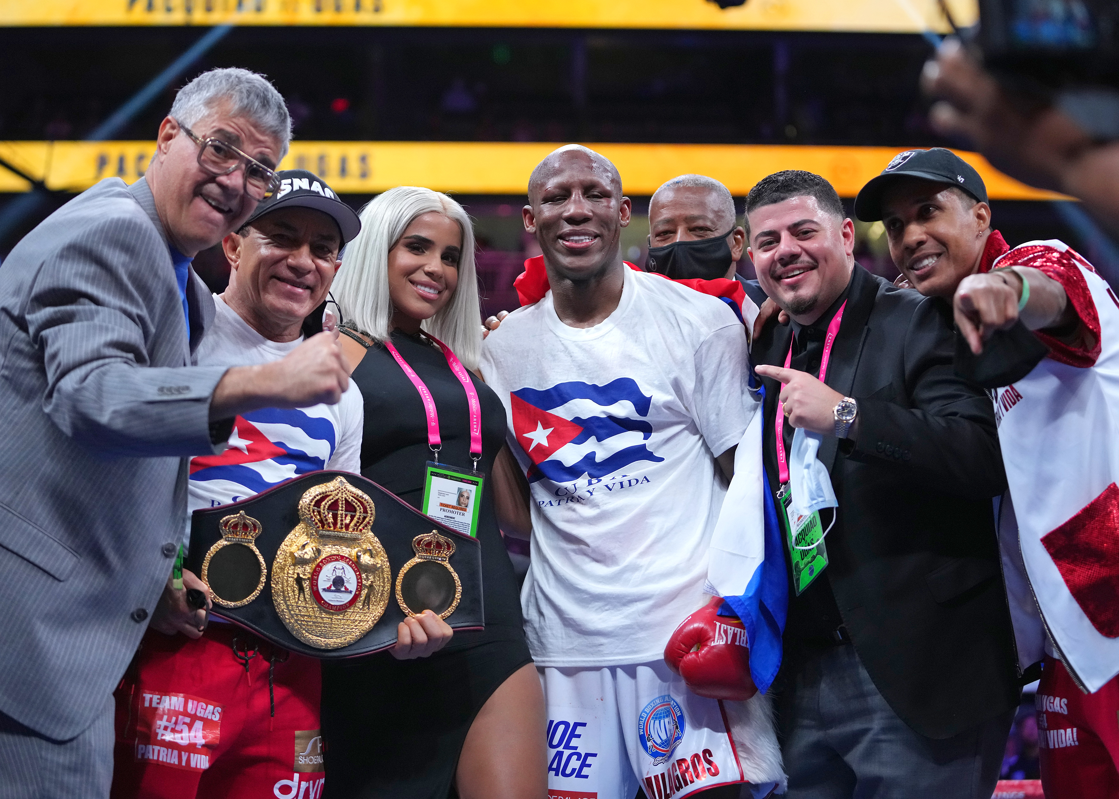 Ugás celebrates with his corner team after defeating Pacquiao on Saturday night