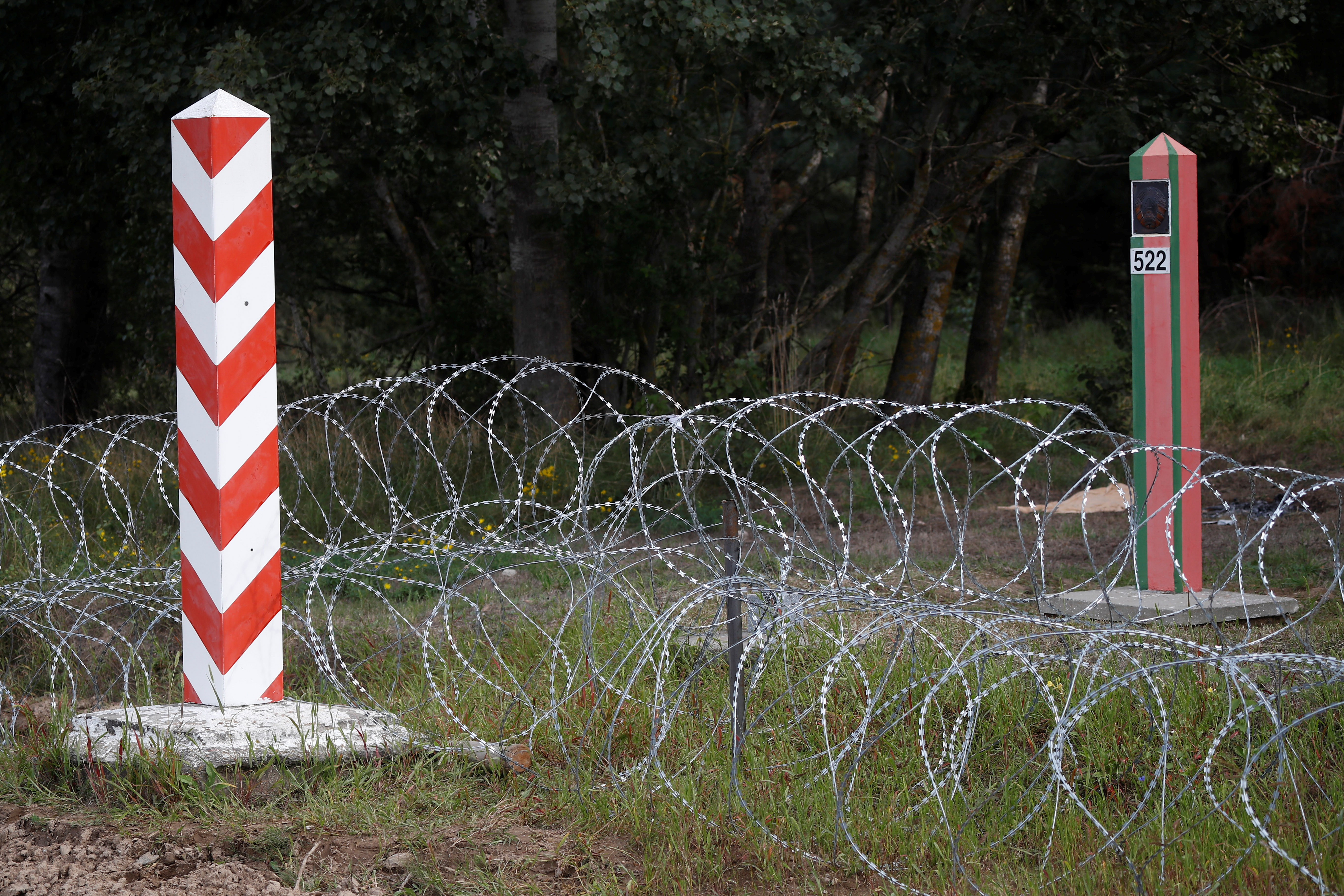 Border signs are pictured at the Polish-Belarusian border near the village of Usnarz Gorny, Poland, August 23