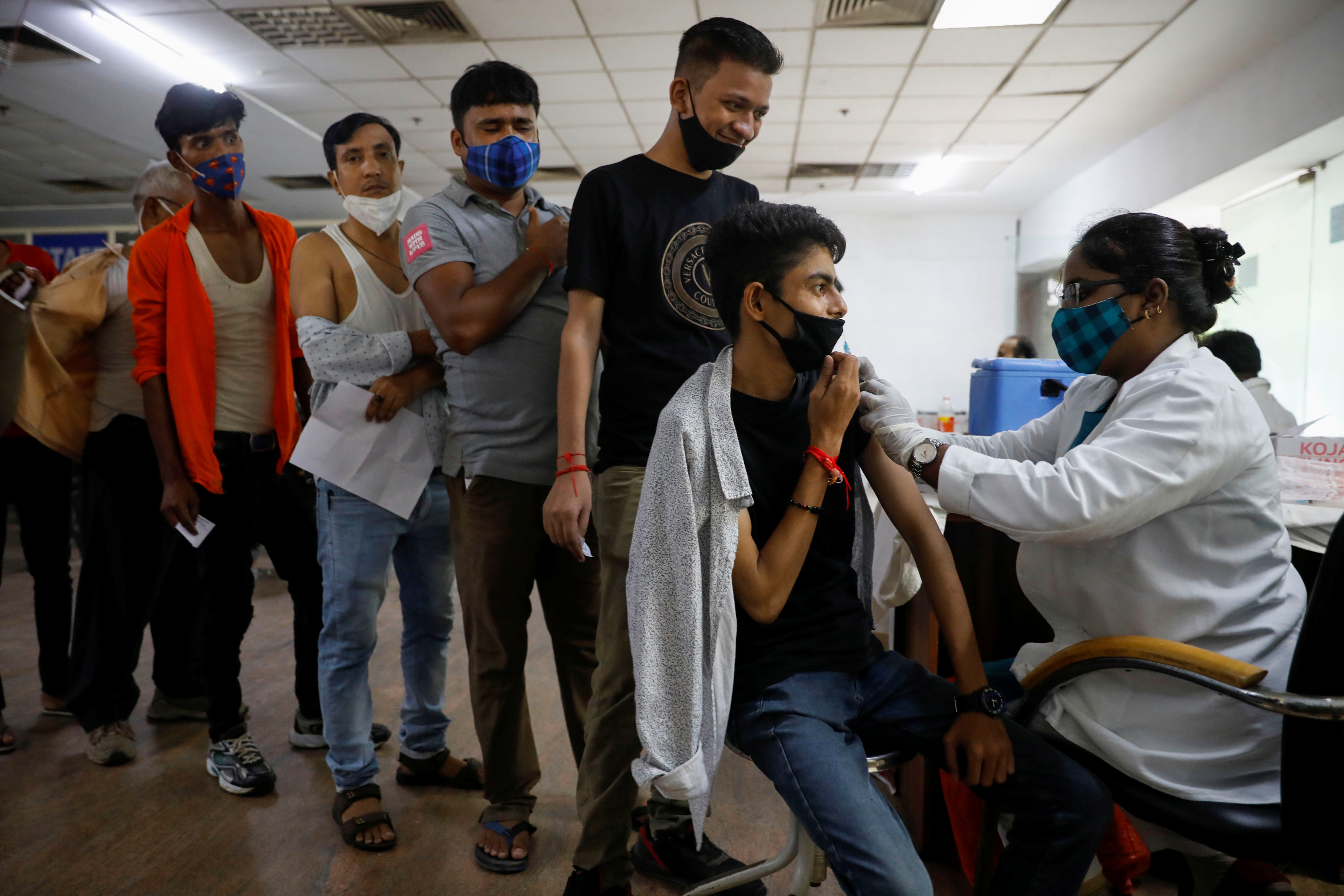 A man receives a dose of Covishield vaccine manufactured by Serum Institute of India, at a hospital in Noida on the outskirts of New Delhi