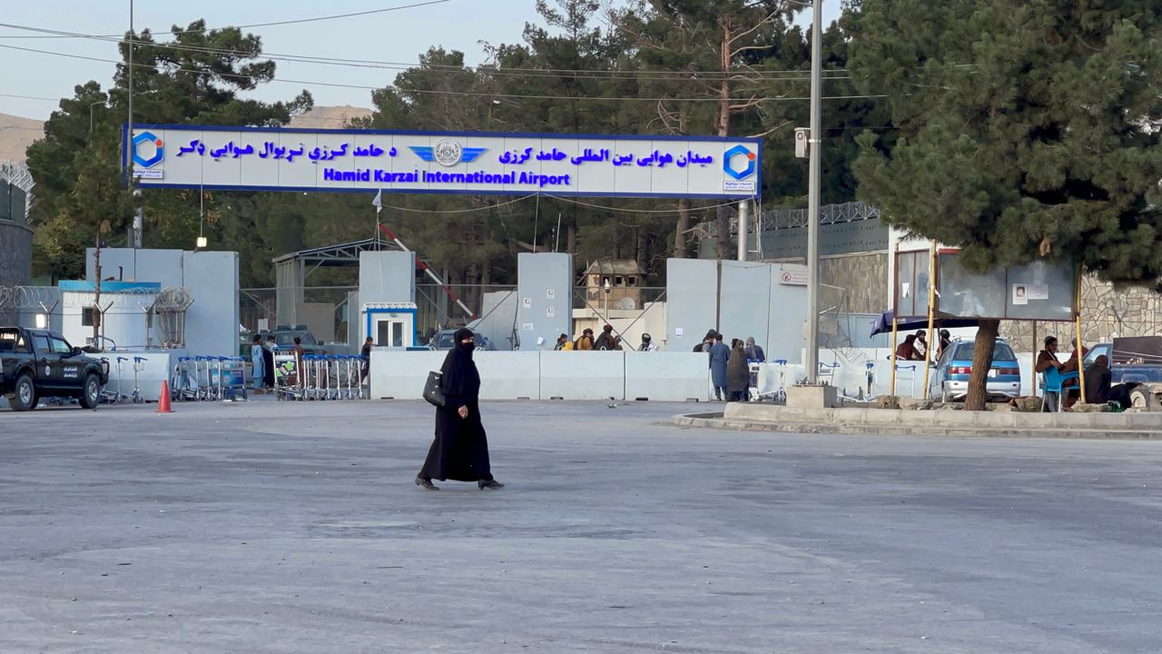 Taliban members stand guard at a checkpoint around Hamid Karzai International Airport