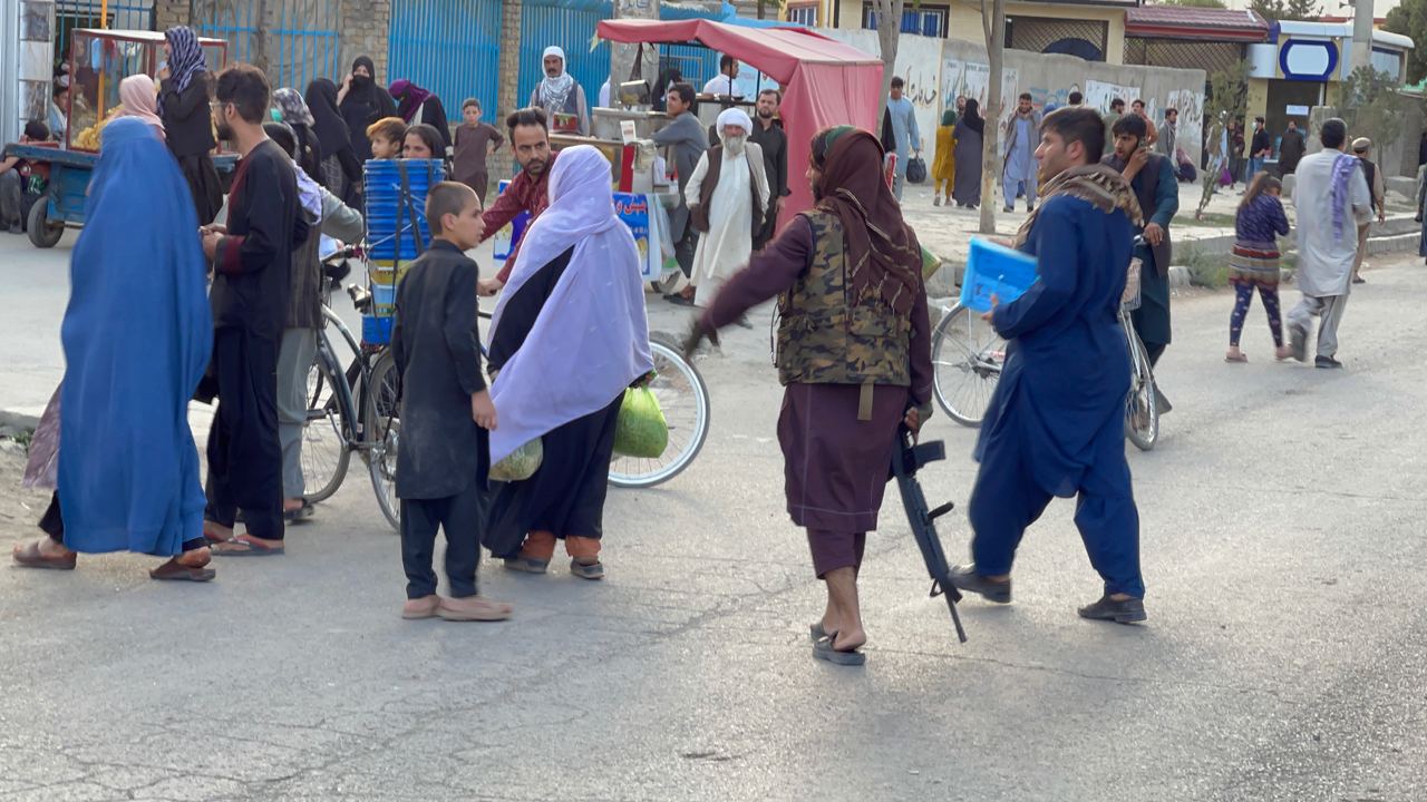 Taliban members stand guard at a checkpoint around Hamid Karzai International Airport, the centre of evacuation efforts from Afghanistan since the Taliban took over