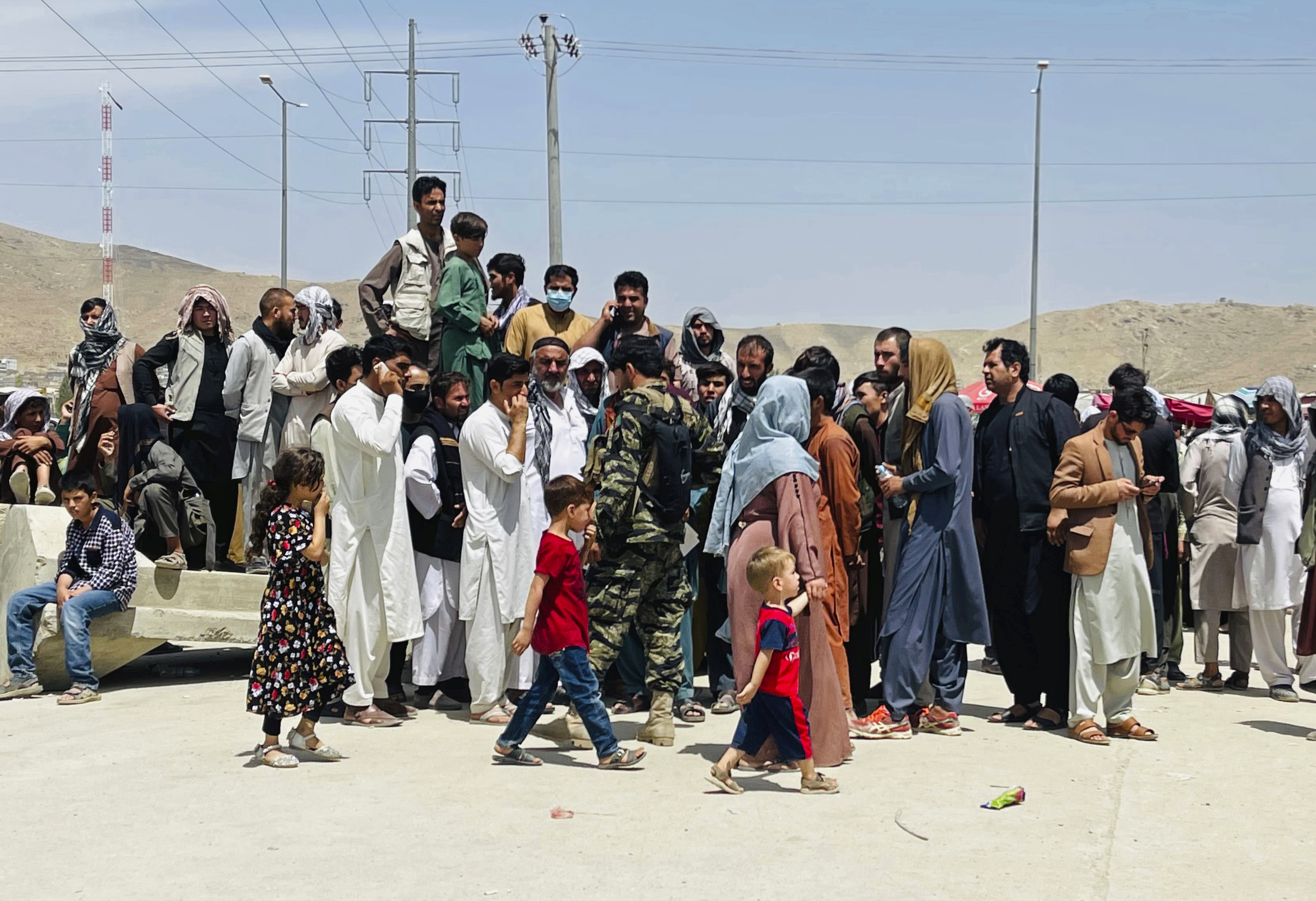 Hundreds of people gather outside the international airport in Kabul, Afghanistan to flee the country [AP Photo]