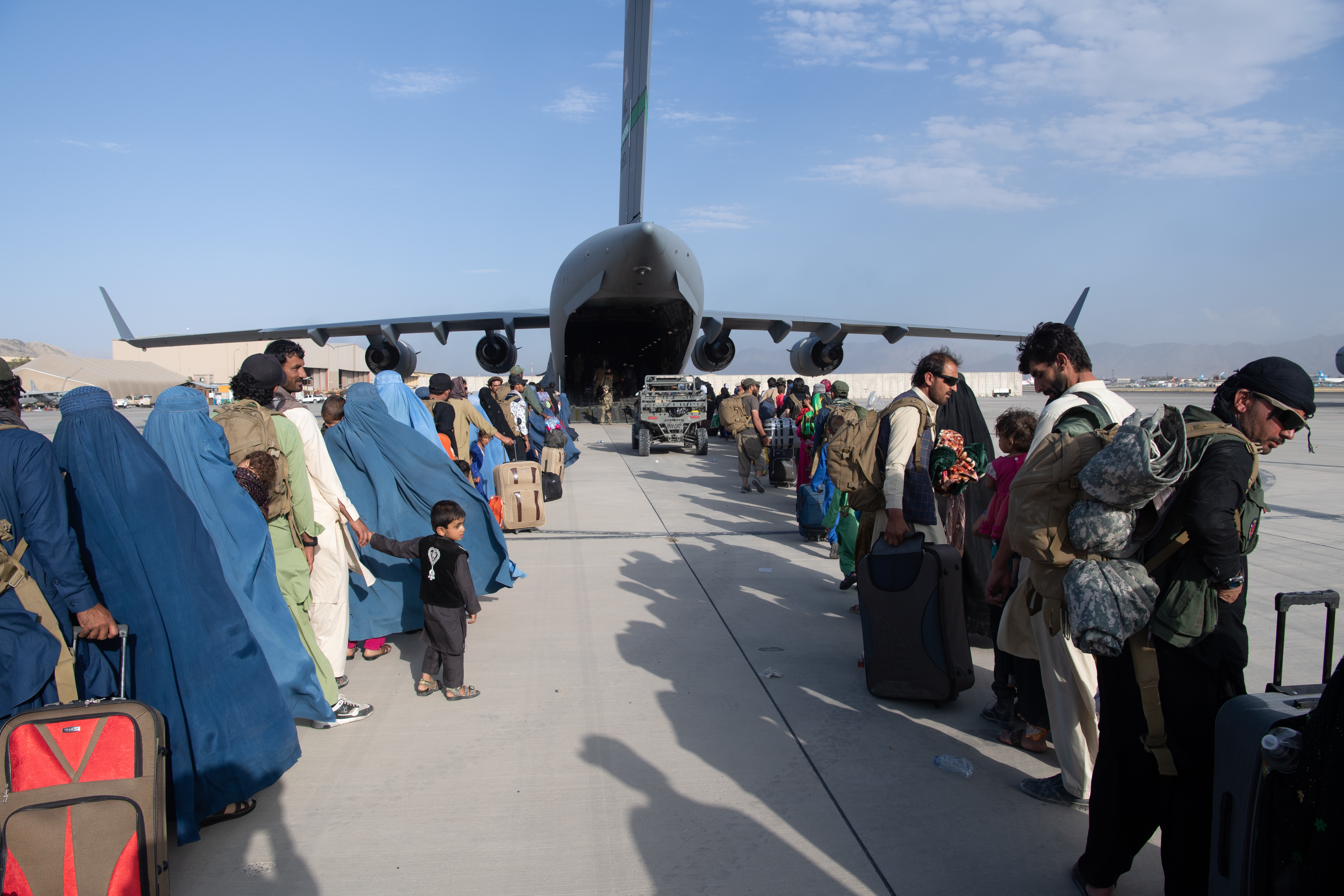 US Air Force loadmasters and pilots assigned to the 816th Expeditionary Airlift Squadron load passengers on board a US Air Force C-17 Globemaster III in support of the Afghanistan evacuation, at Hamid Karzai International Airport (HKIA) on August 24, 2021 in Kabul, Afghanistan