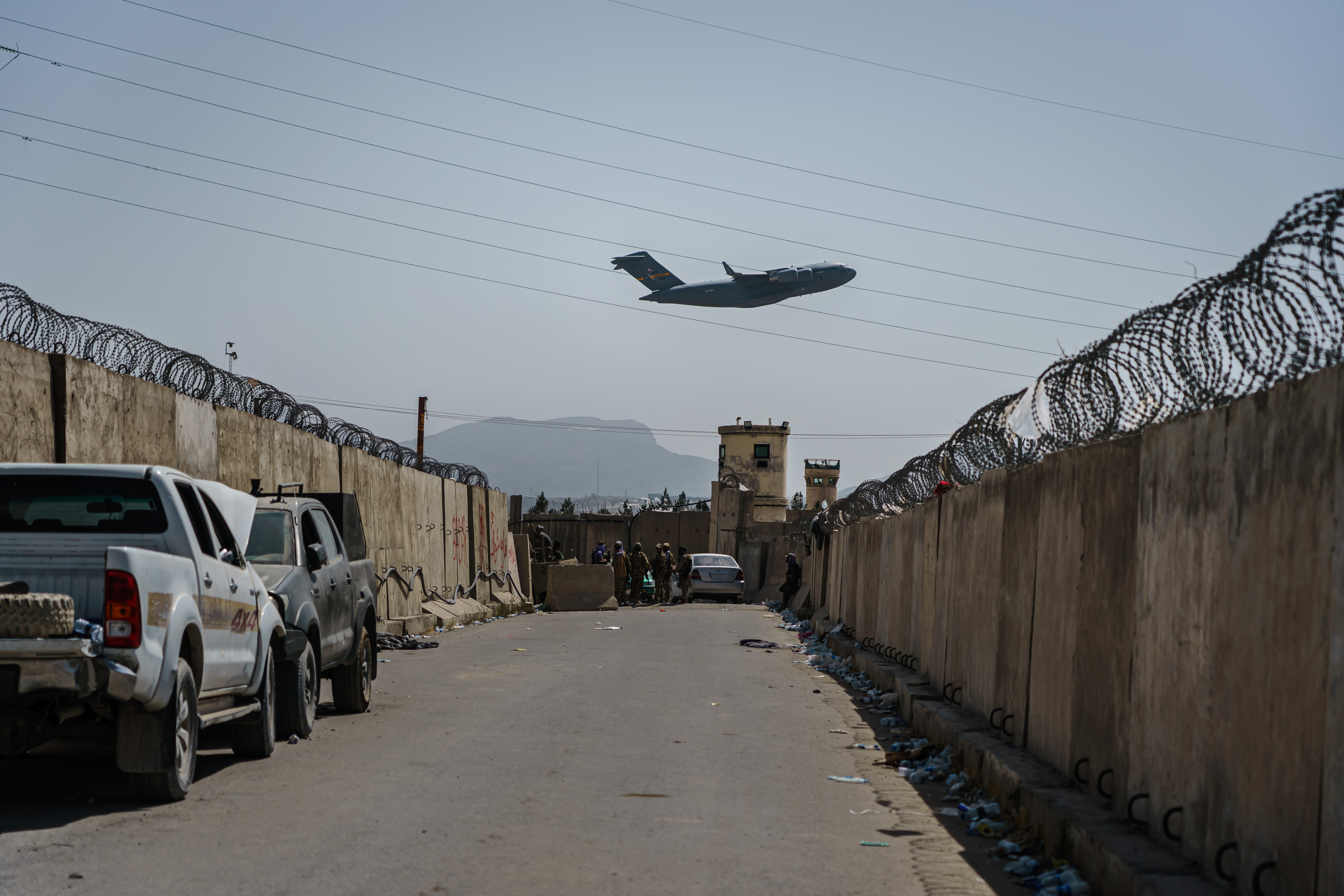A C-17 Globemaster takes off as Taliban fighters secure the outer perimeter of Kabul international airport