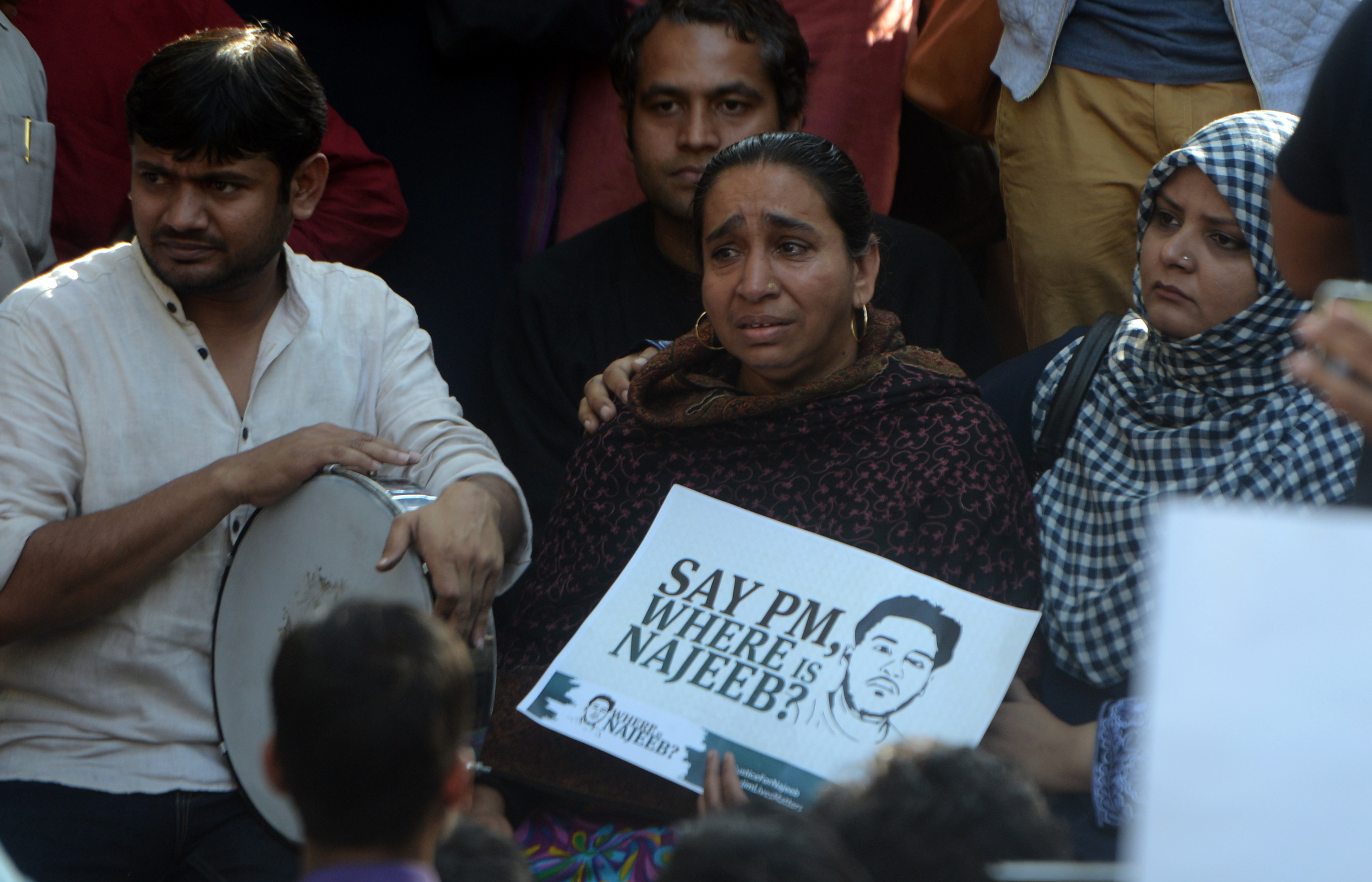 Fatima Nafees, holding placard, with ex-JNU student leader Kanhaiya Kumar, left, and others during a protest march in New Delhi