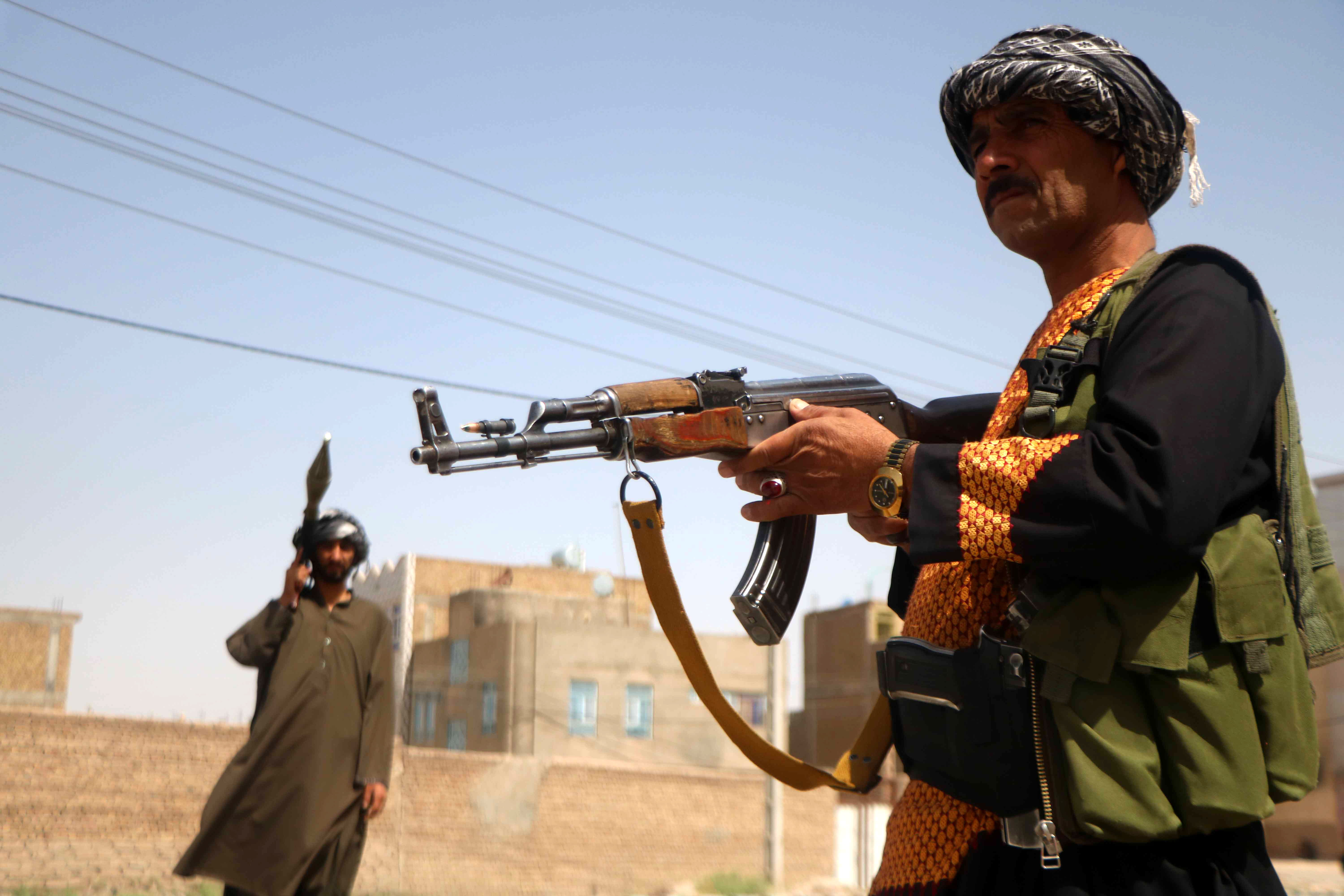 Armed Afghans stand guard at a check point in the Pul-e Malan area of Guzara district in Herat, Afghanistan [Jalil Rezayee/EPA]