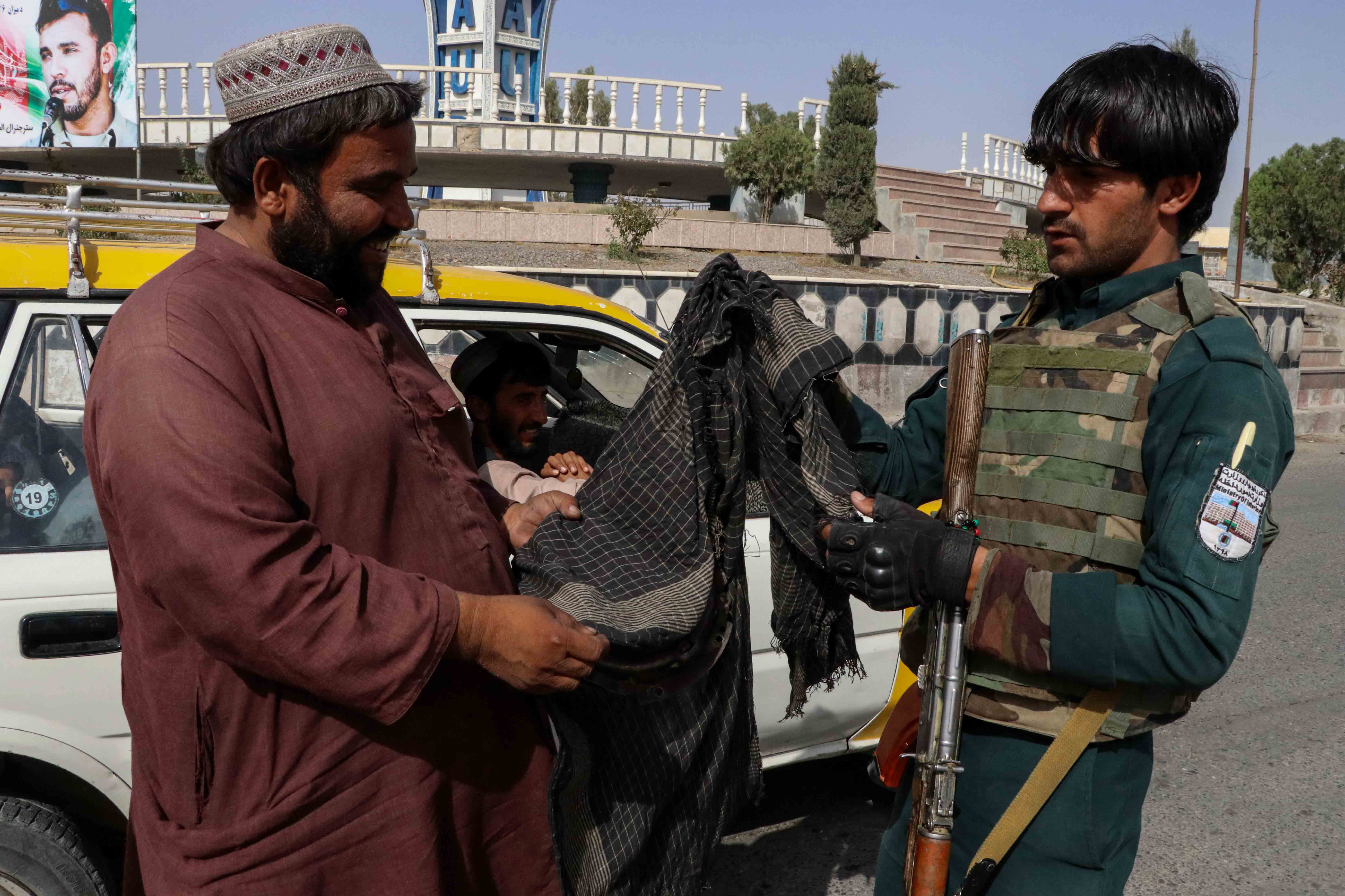 An Afghan security official checks vehicles at a check point in Kandahar, Afghanistan, 12 August 2021