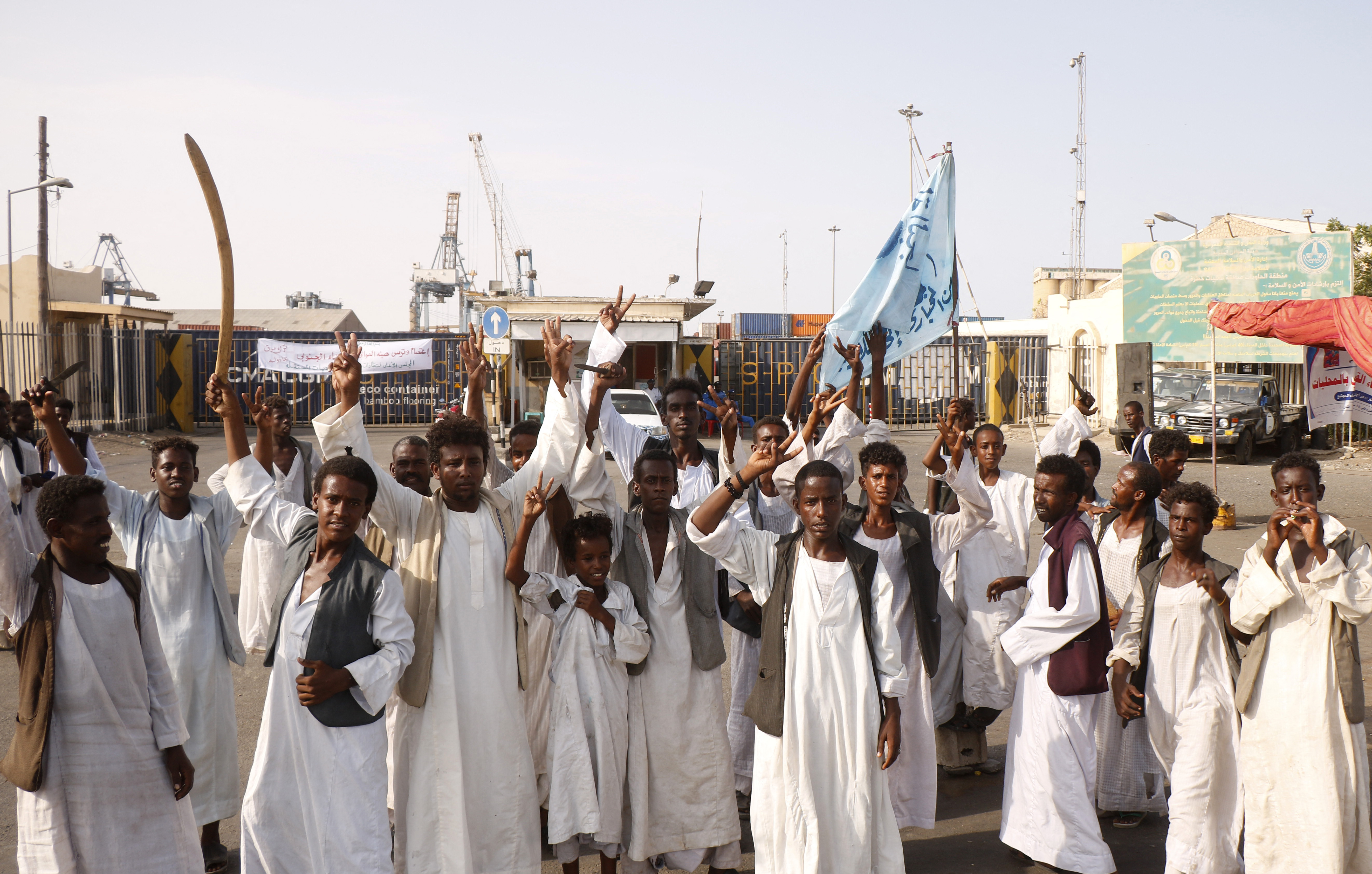 Sudanese protesters gather outside the main entrance to the southern port in Port Sudan
