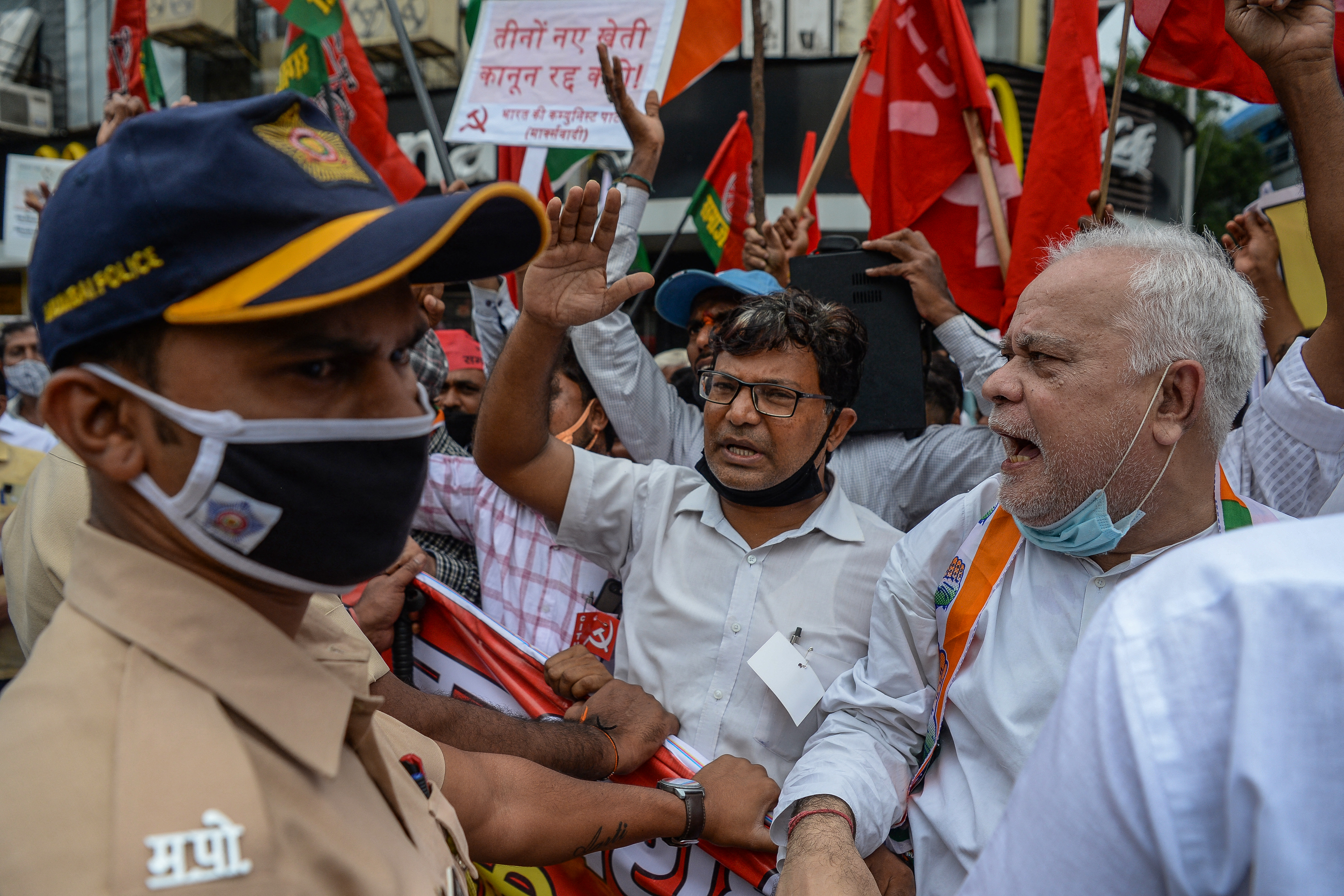 Activists in support of the protesting famers shout slogans during a demonstration in Mumbai