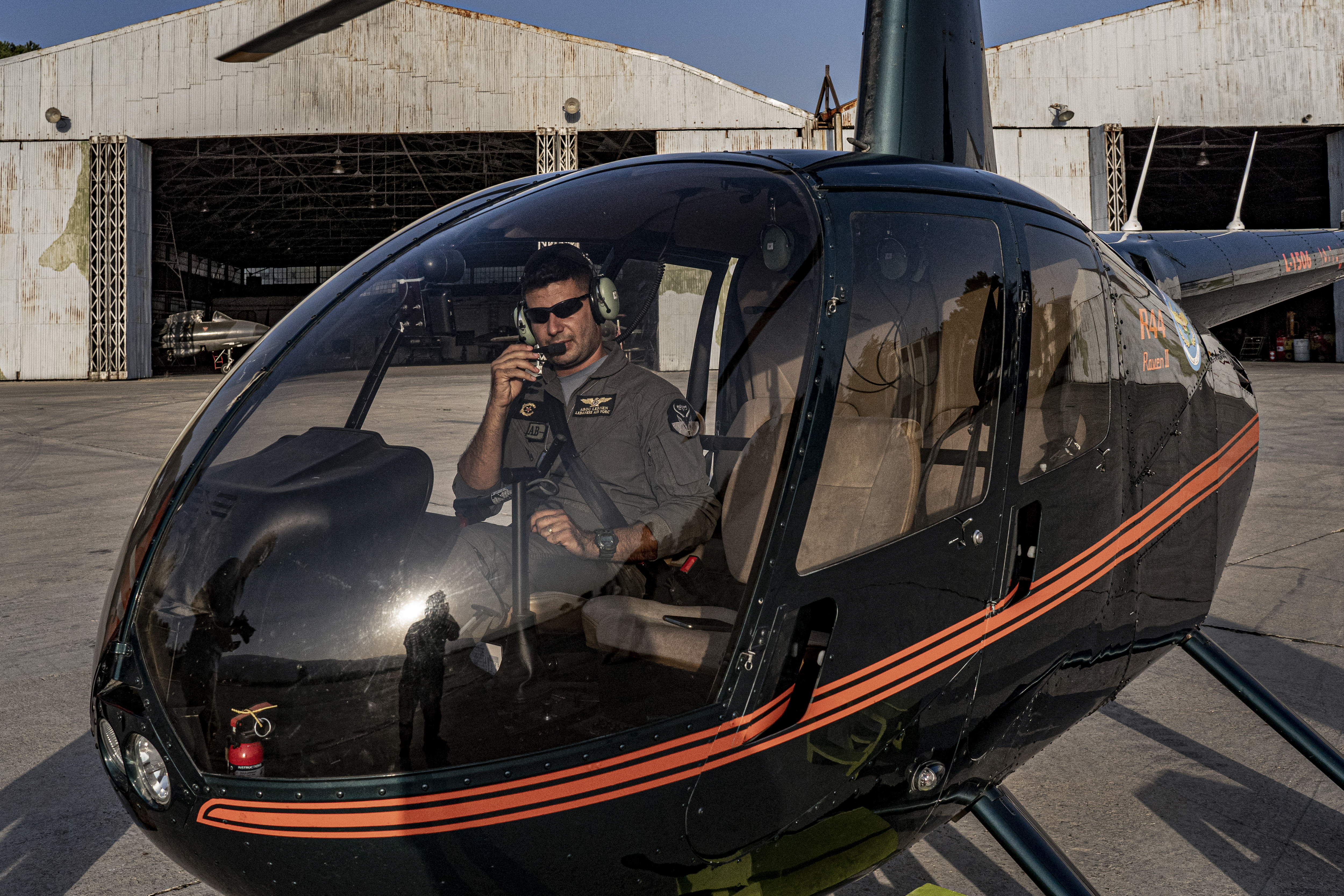 A Lebanese army pilot prepares a R44 Raven II helicopter for tourists at the Rayak airbase in the Bekaa Valley. Since July 2021, Lebanon’s struggling military has been offering tourists helicopter rides in a desperate bid to raise money. [Tariq Zaidi/Al Jazeera]