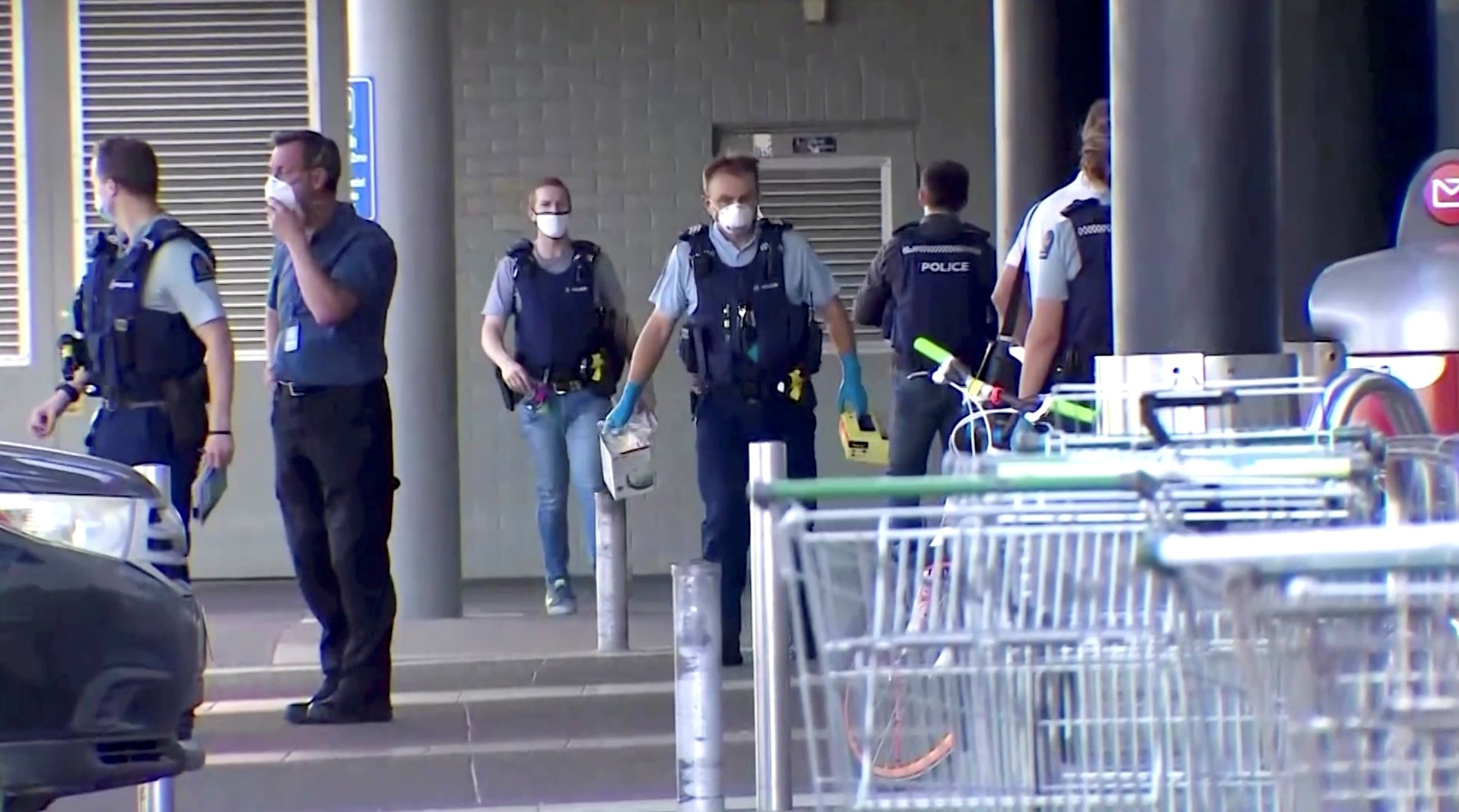A screengrab shows police officers working outside a shopping mall following a knife attack in Auckland [TVNZ via Reuters TV]