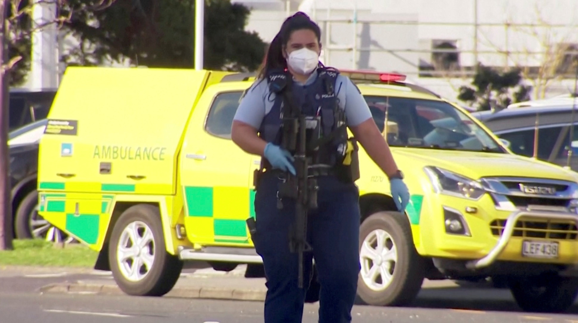 A screengrab shows a police officer walking with a gun outside the shopping mall [TVNZ via Reuters]