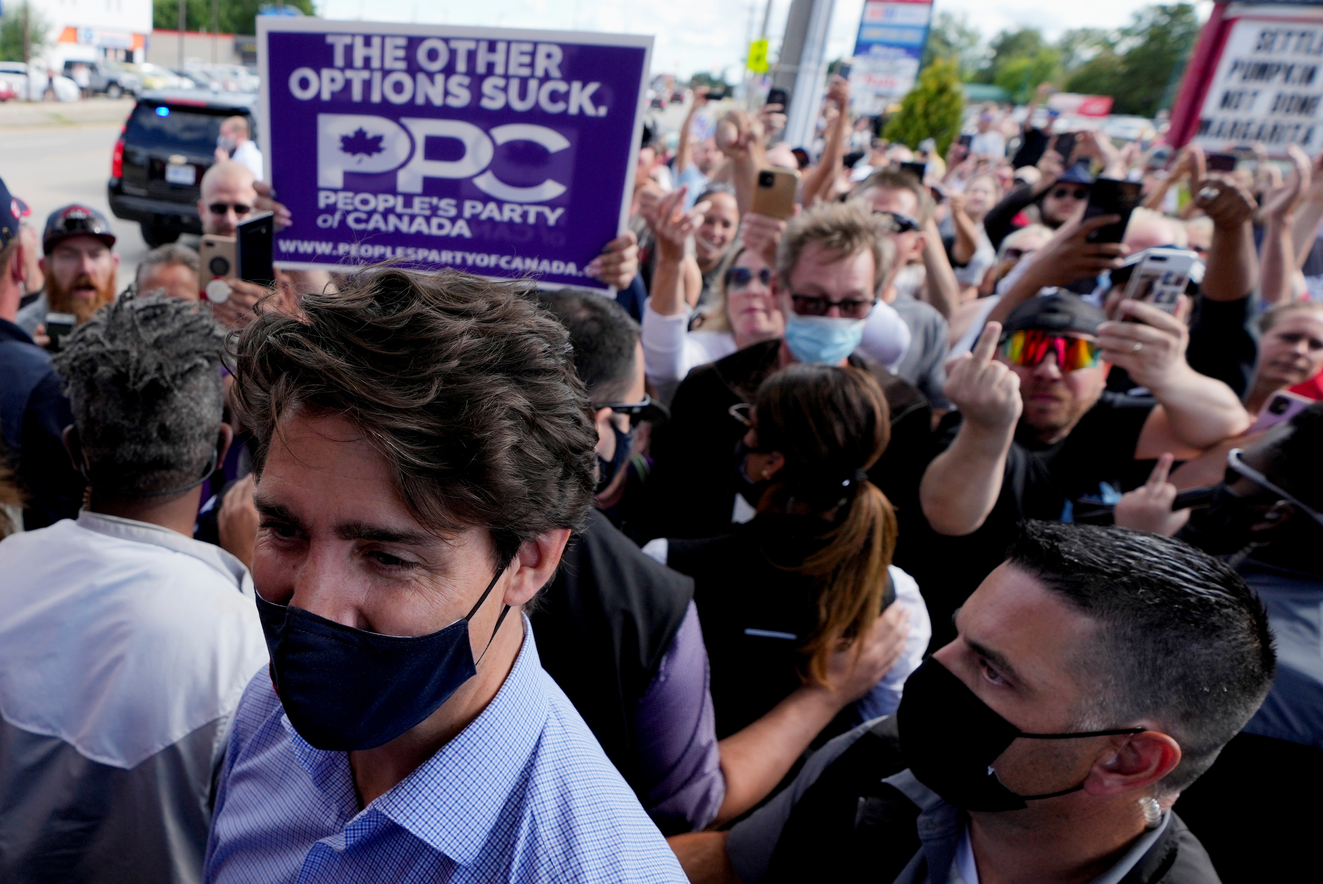 Protesters gesture towards Canada’s Liberal Prime Minister Justin Trudeau at his election campaign tour stop in Brantford, Ontario, Canada
