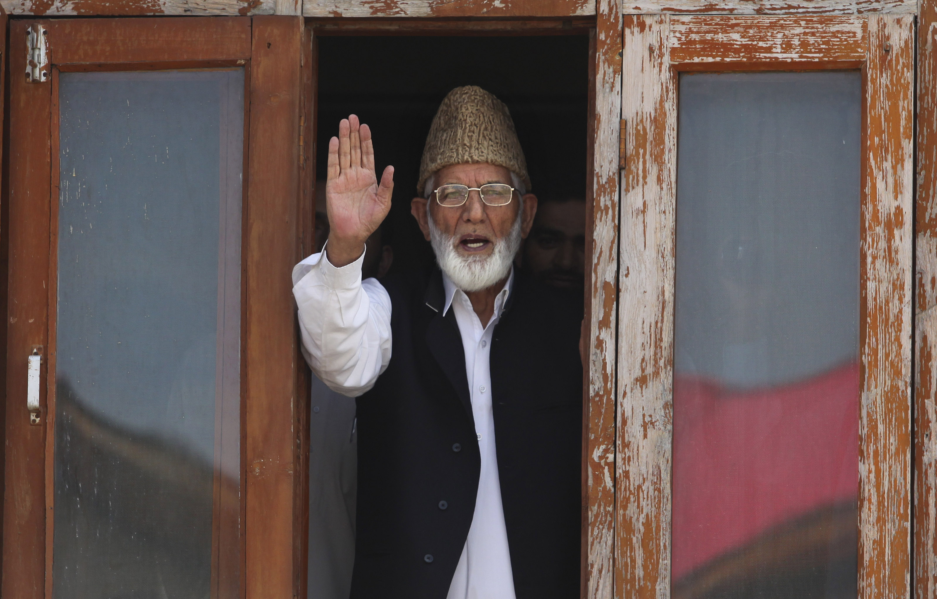 Geelani gestures as he speaks to media before his arrest in Srinagar