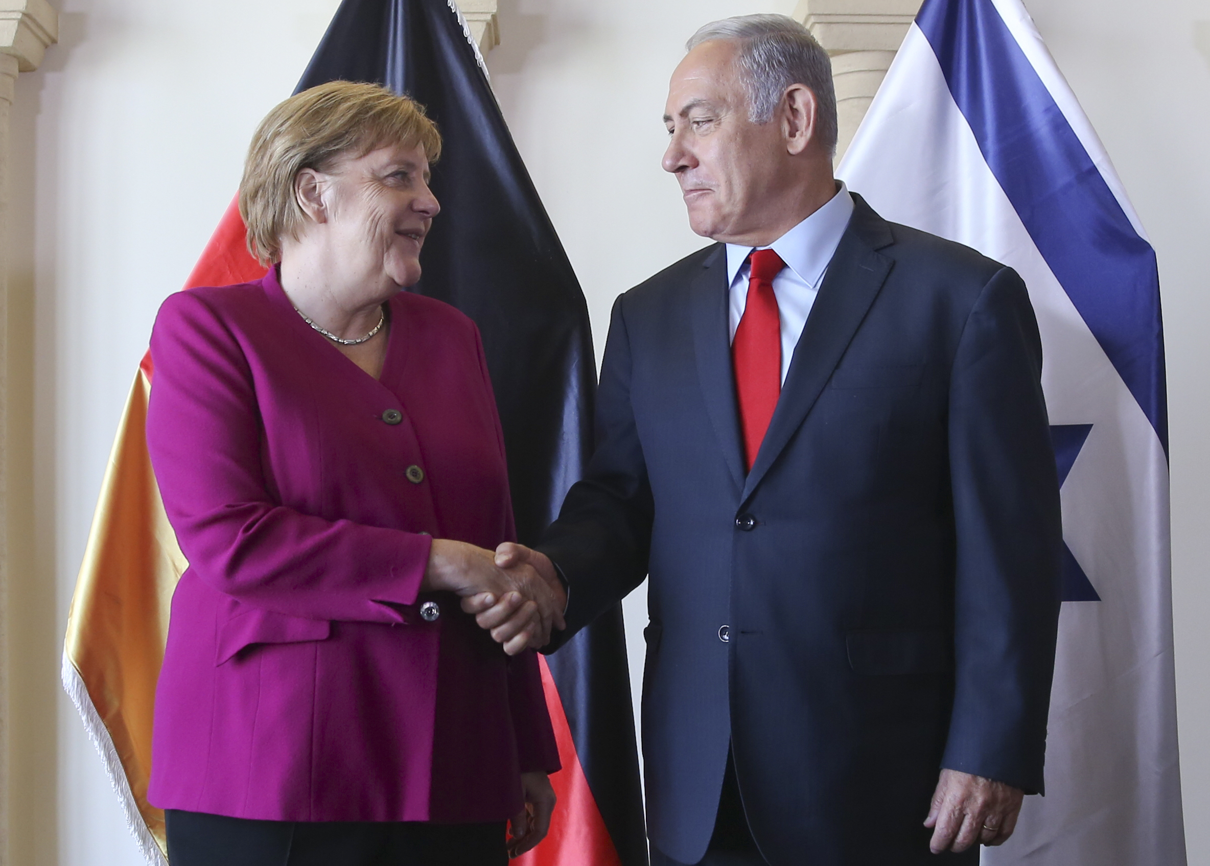 Israeli Prime Minister Benjamin Netanyahu and German Chancellor Angela Merkel pose photographers between meetings in Jerusalem, Thursday, October 4, 2018