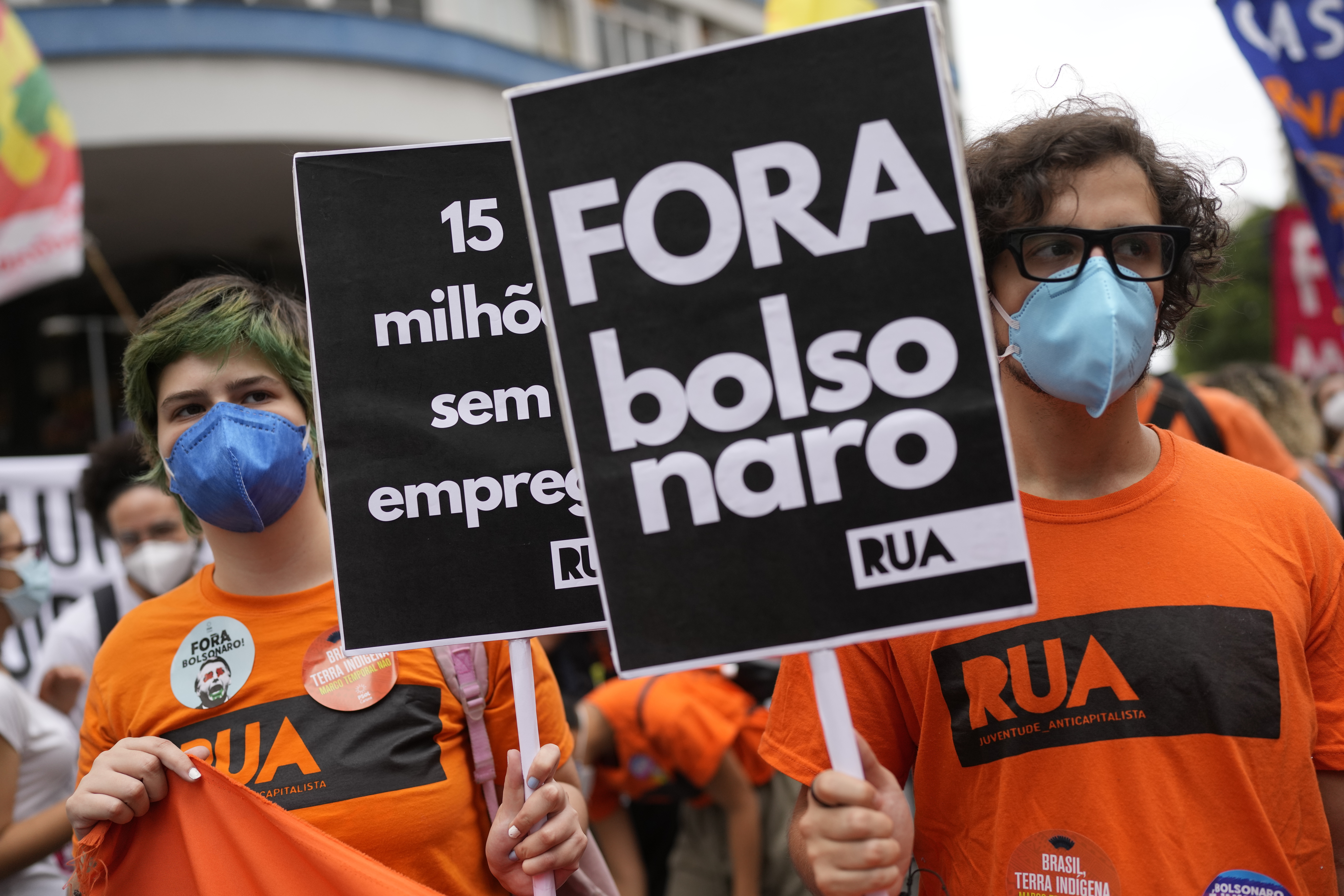 A protester holds a sign reading, ‘Get out now Bolsonaro’ during a rally in Rio de Janeiro last month against the president’s handling of the pandemic