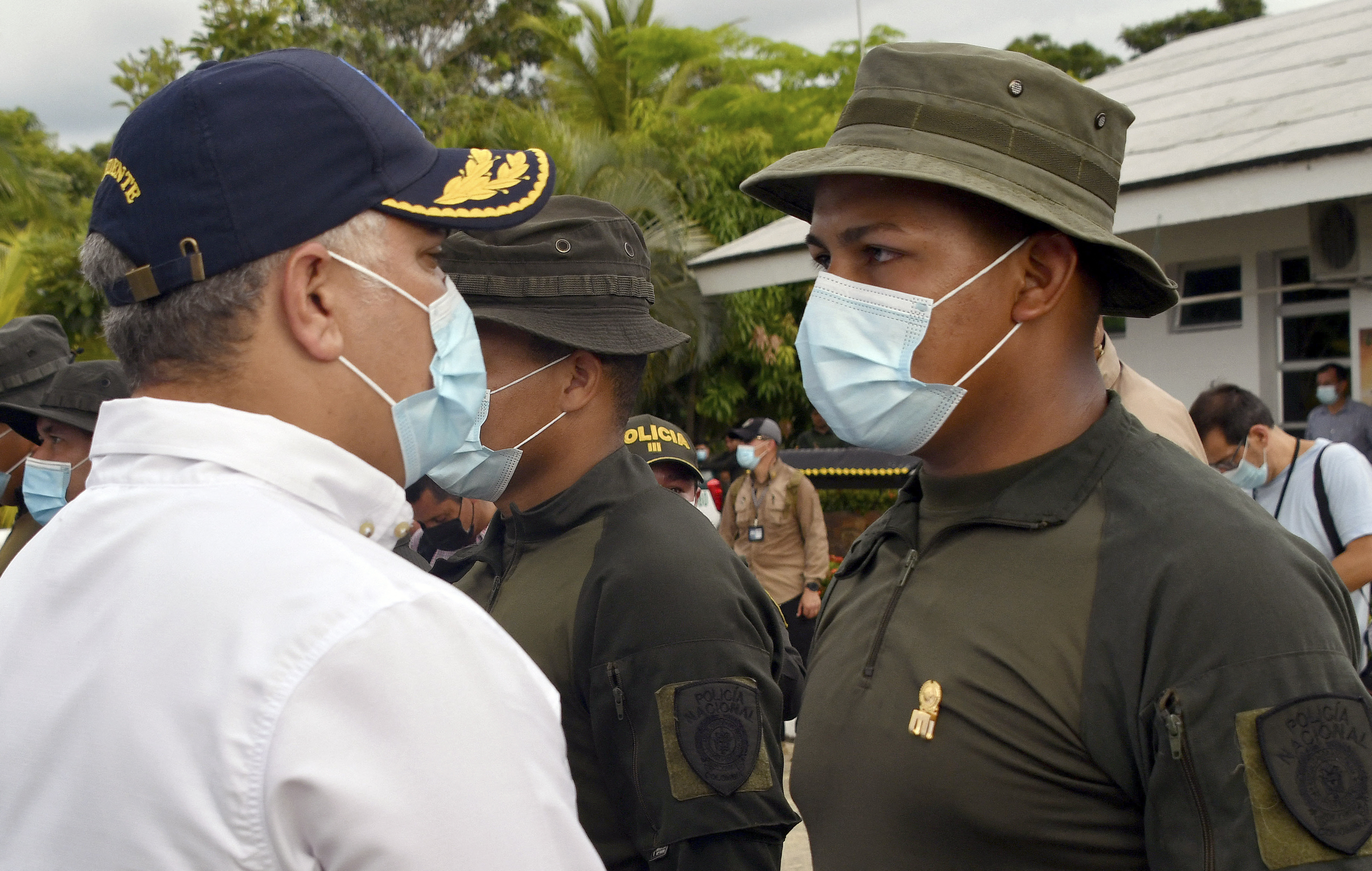 Colombian President Ivan Duque (left) congratulates a soldier who participated in the capture of drug lord Dairo Antonio Usuga, during a ceremony in Carepa military base, on October 24
