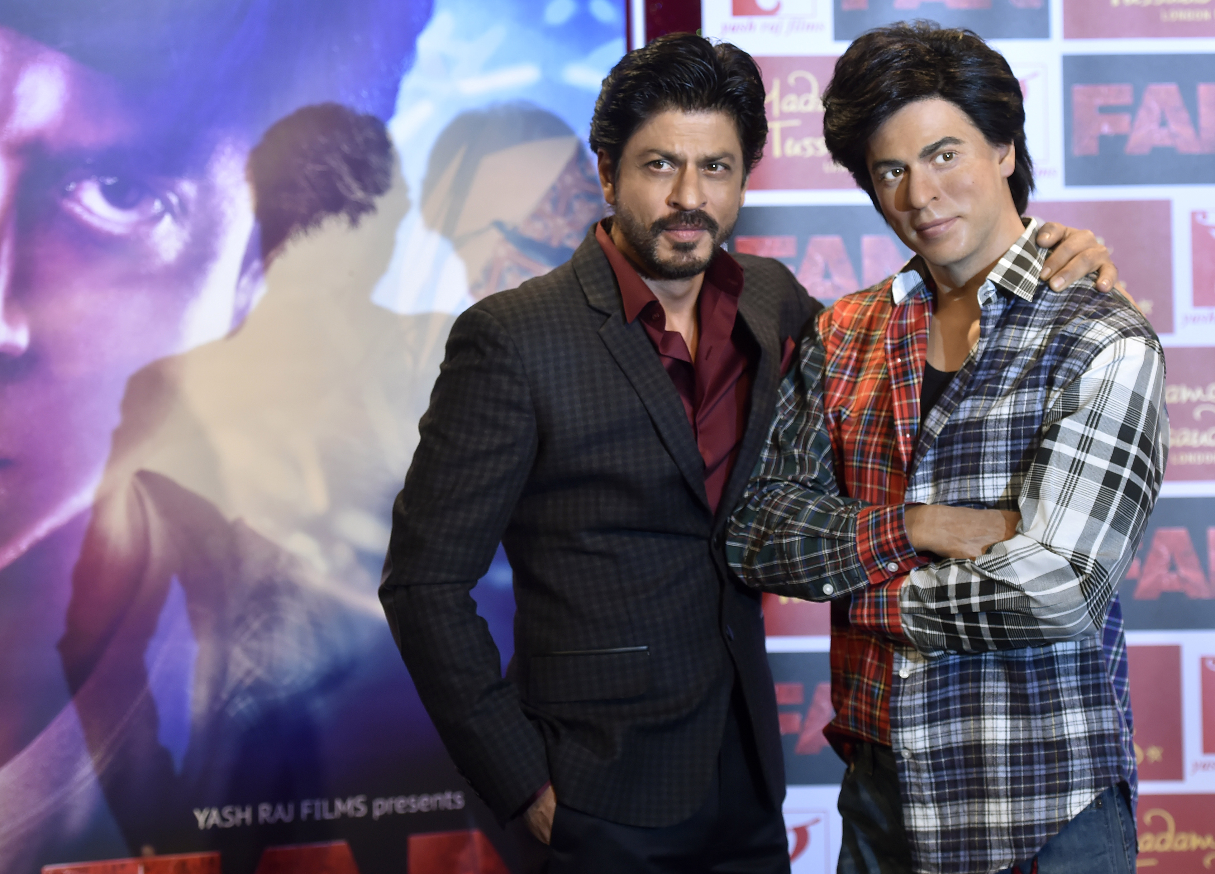 Shah Rukh Khan, left, poses with a waxwork model of himself at Madame Tussauds in London