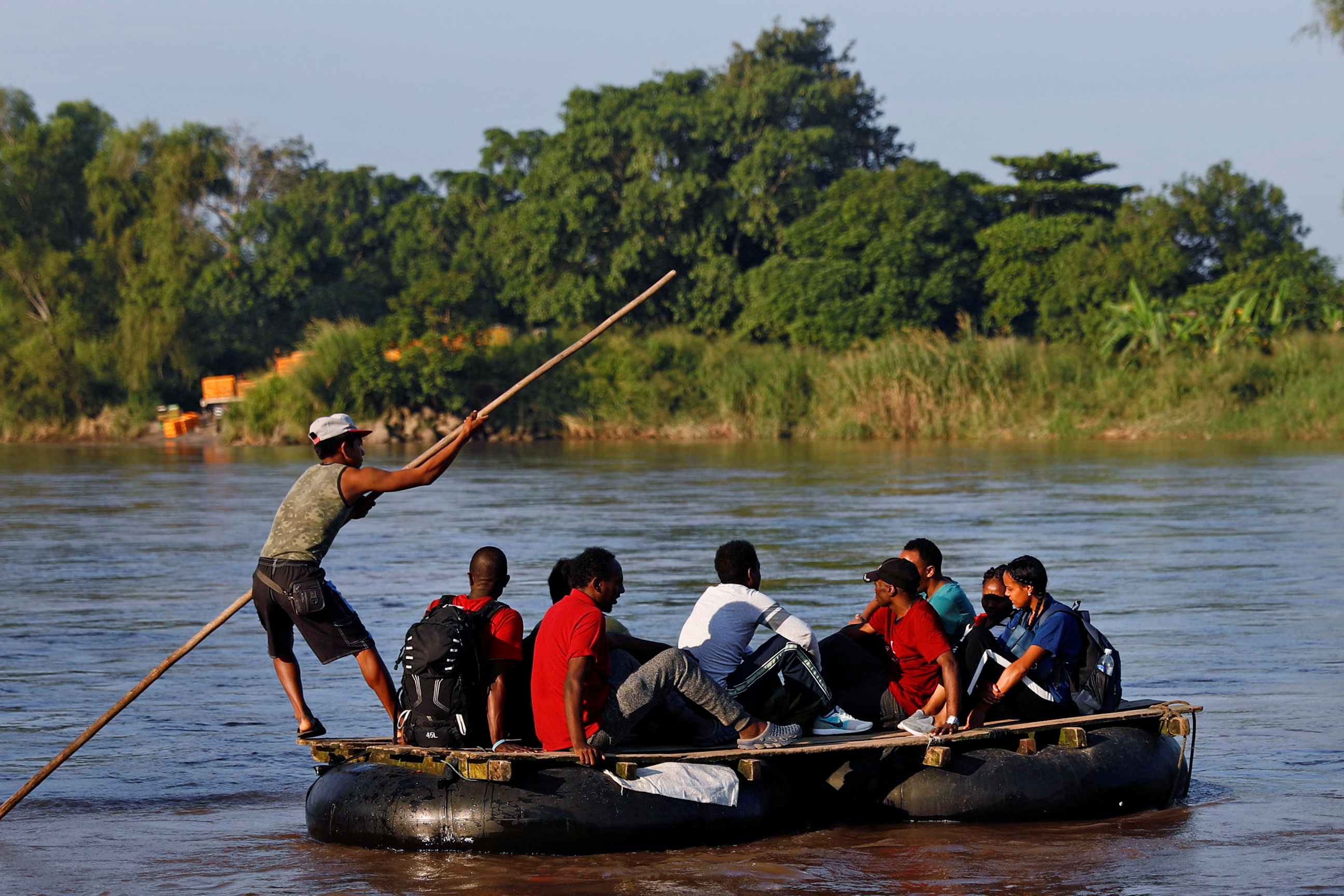 African migrants cross the Suchiate River on a raft to avoid the border checkpoint in Ciudad Hidalgo, Mexico, in 2018