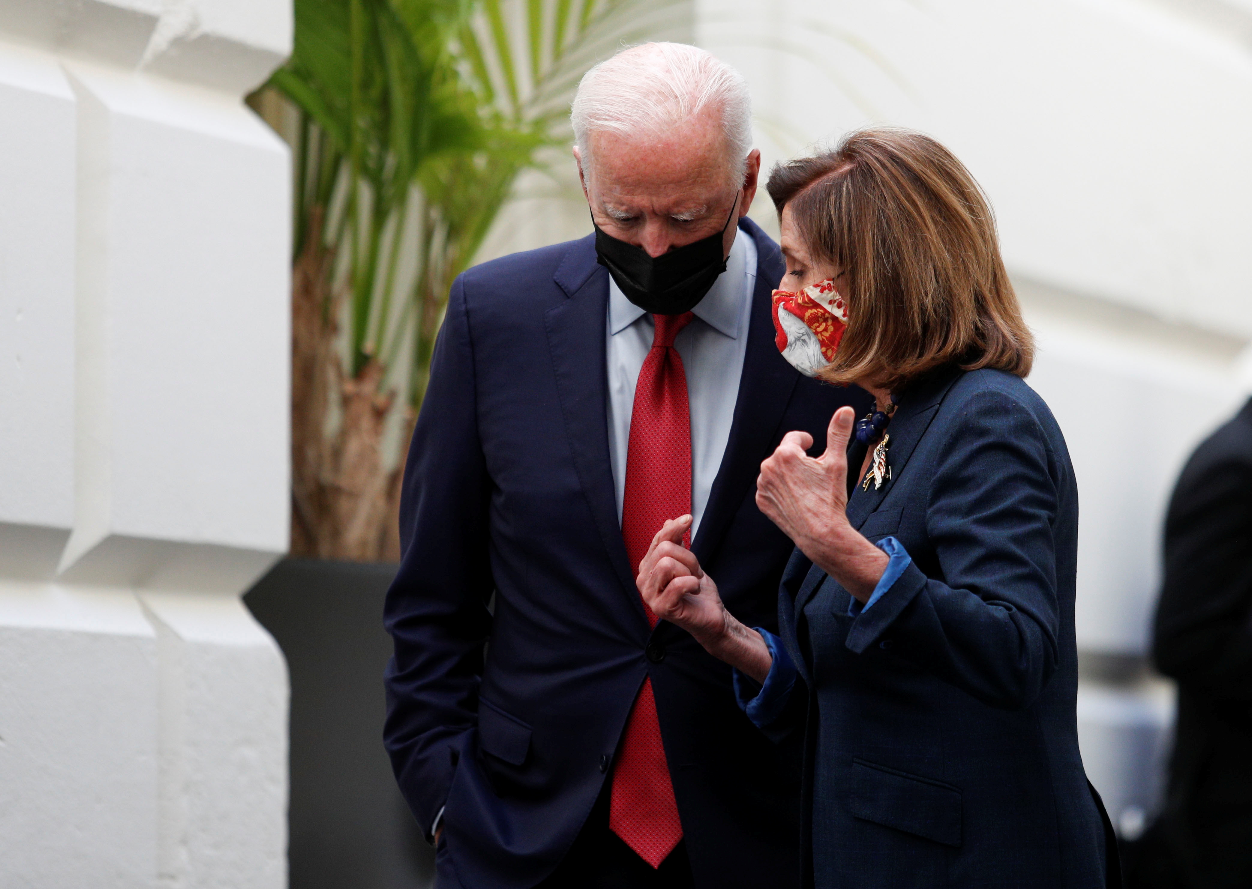 US President Joe Biden talks with Speaker of the House Nancy Pelosi as they walk out of a meeting held with Democratic lawmakers at the US Capitol