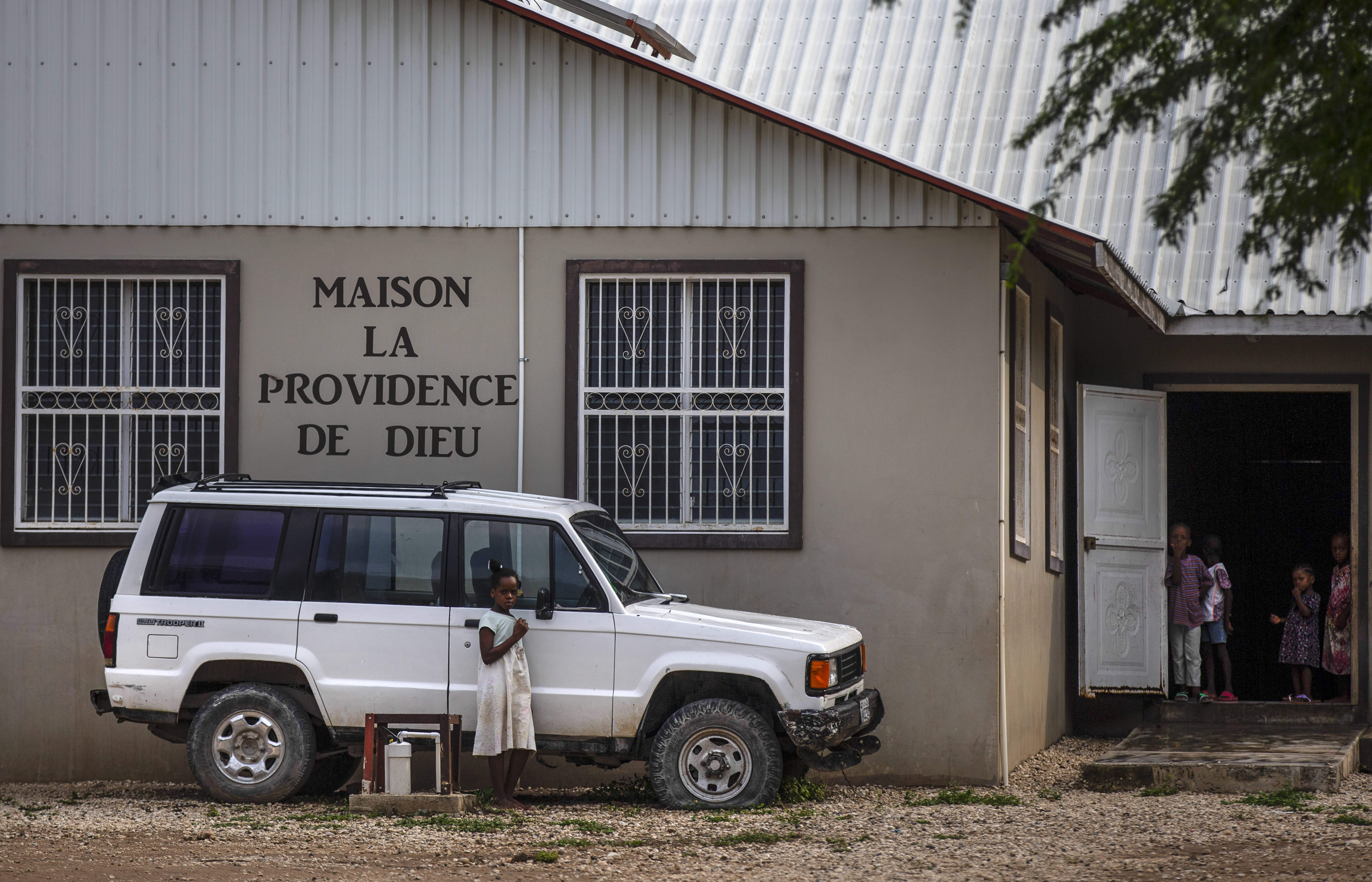 Children stand in the courtyard of the Maison La Providence de Dieu orphanage in Ganthier, Croix-des-Bouquets, on Sunday following the abduction of the missionaries