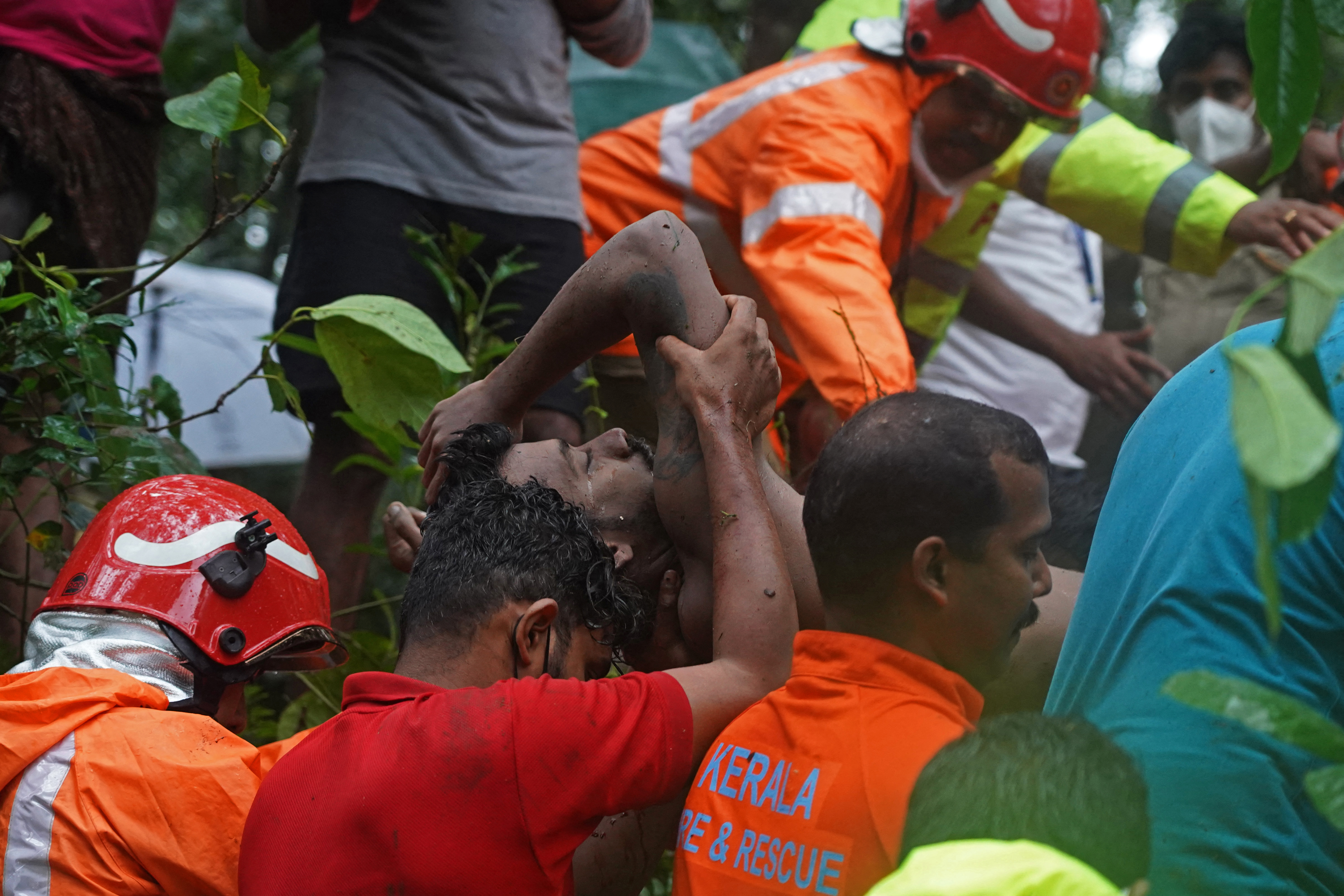Members of a rescue team carry the body of a flash flood victim in India’s Kerala state on Saturday
