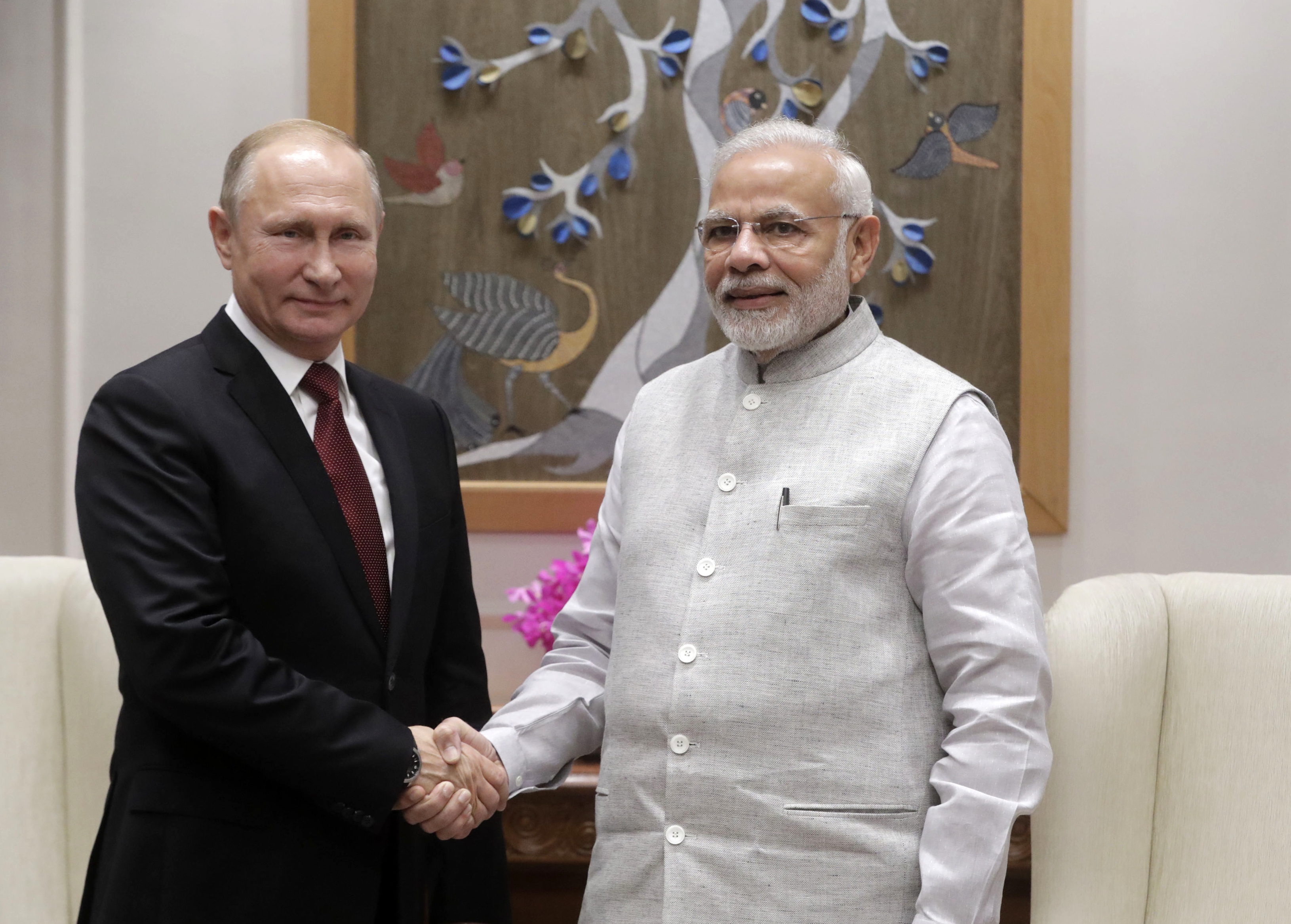 Russian President Vladimir Putin, (left), shakes hands with Indian Prime Minister Narendra Modi during their meeting in New Delhi on October 4, 2018