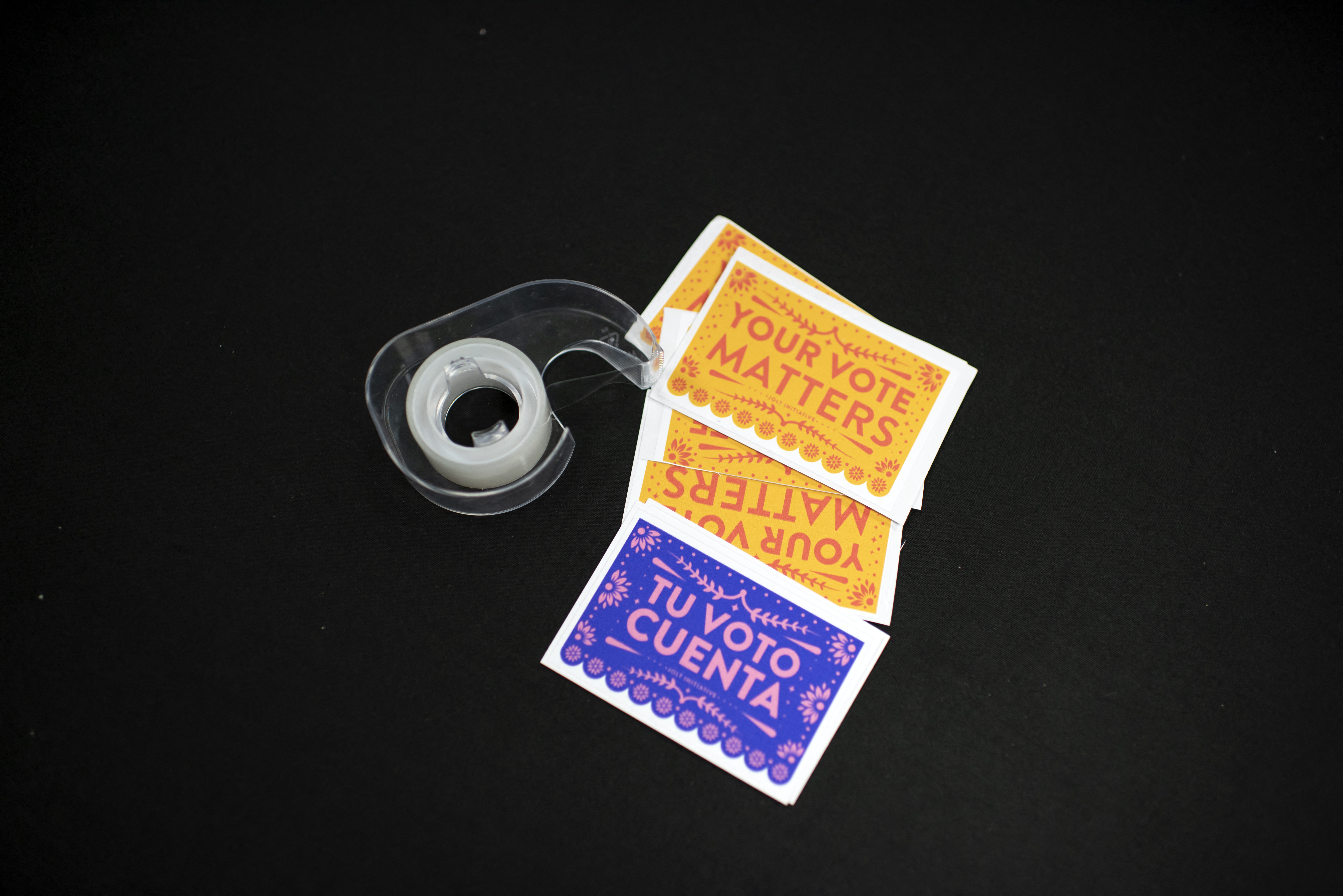 Stickers in Spanish and English and a roll of tape sit on a table at the headquarters of Jolt, a non-profit organisation that works to increase the civic participation of Latinos in Texas