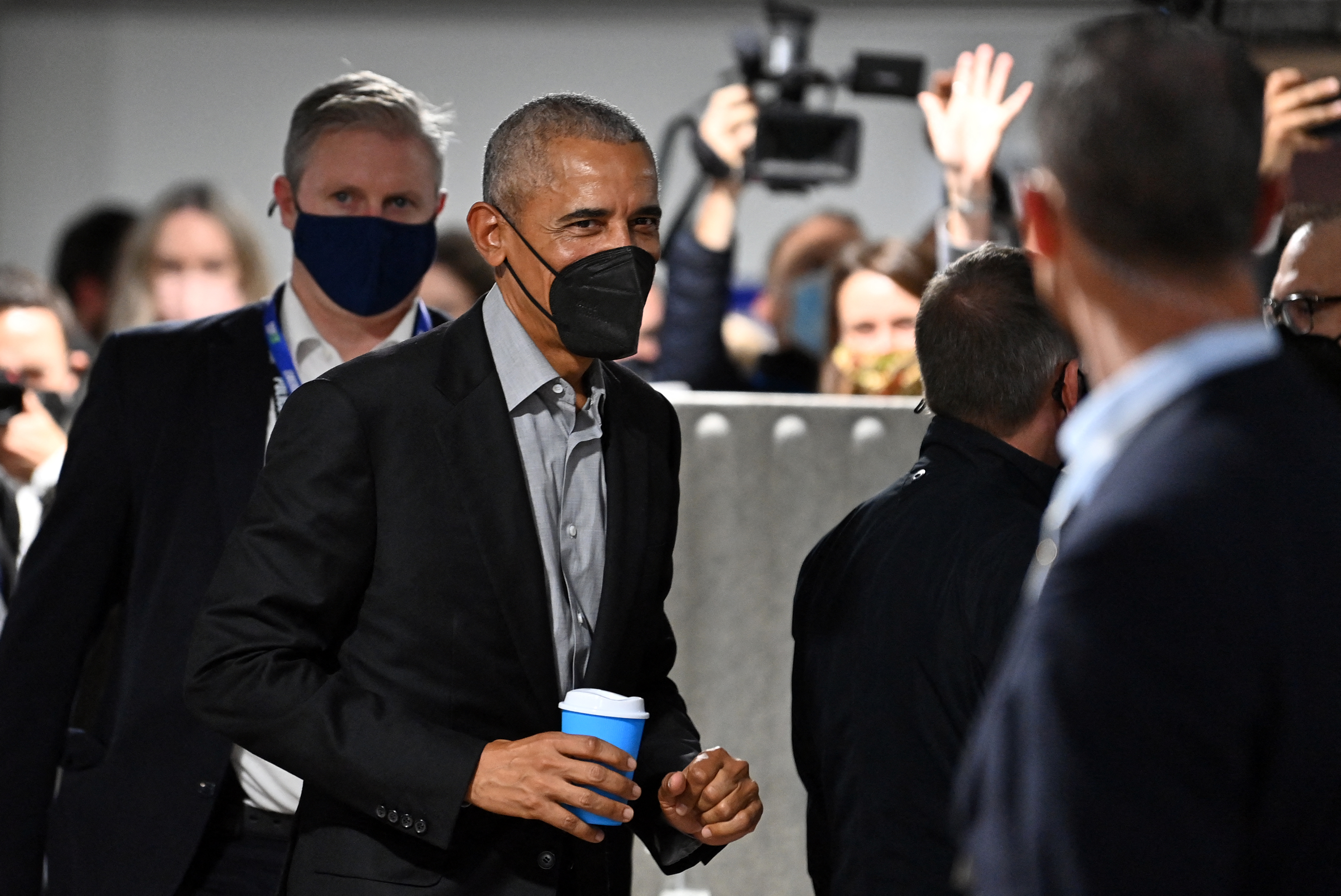 Former US President Barack Obama, wearing a face-covering due to COVID-19, leaves after attending a meeting at the COP26 UN Climate Change Conference in Glasgow on November 8, 2021