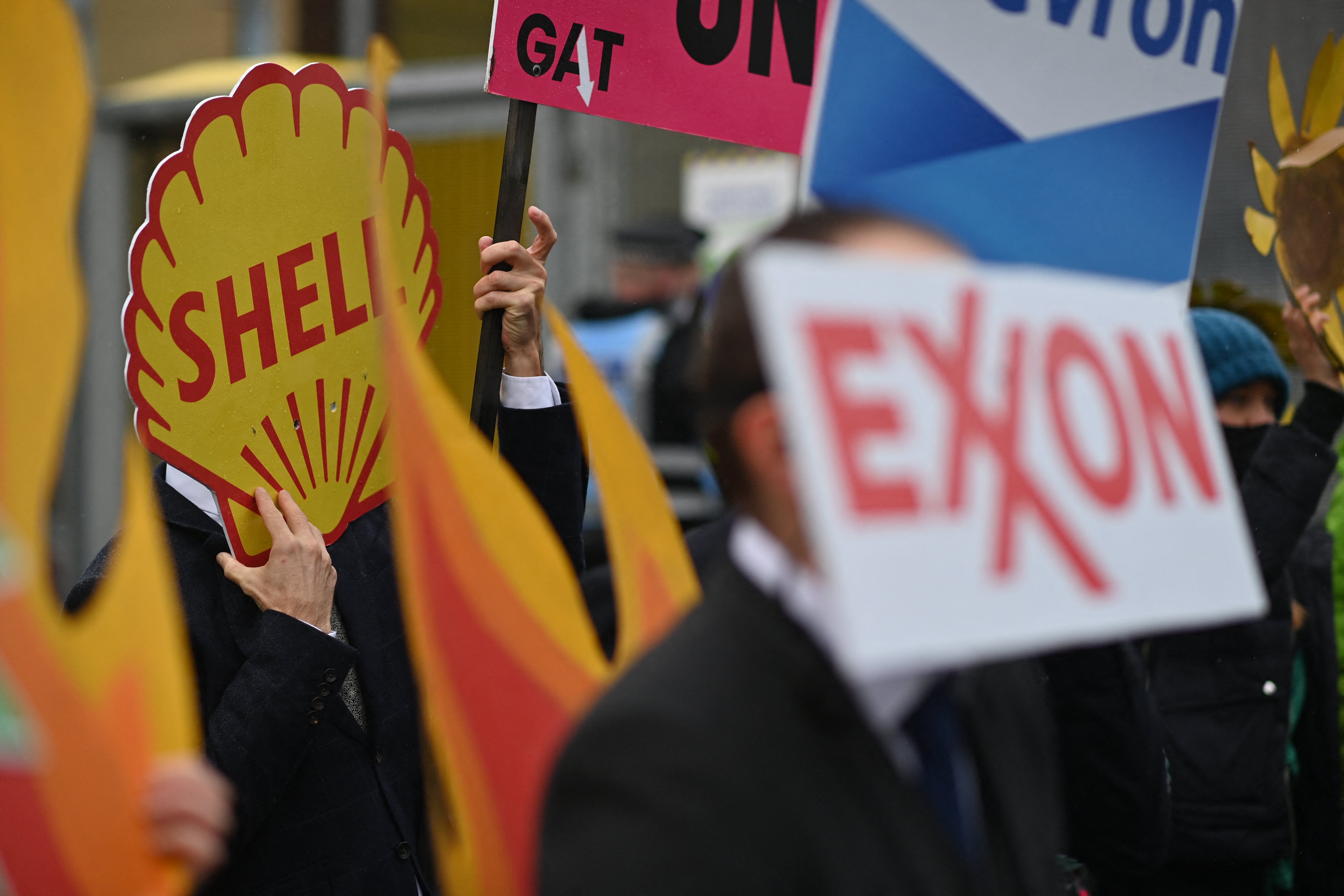 Climate activists carry placards as they participate in an anti-fossil fuel protest action in Glasgow on November 12, 2021, during the COP26 UN Climate Change Conference