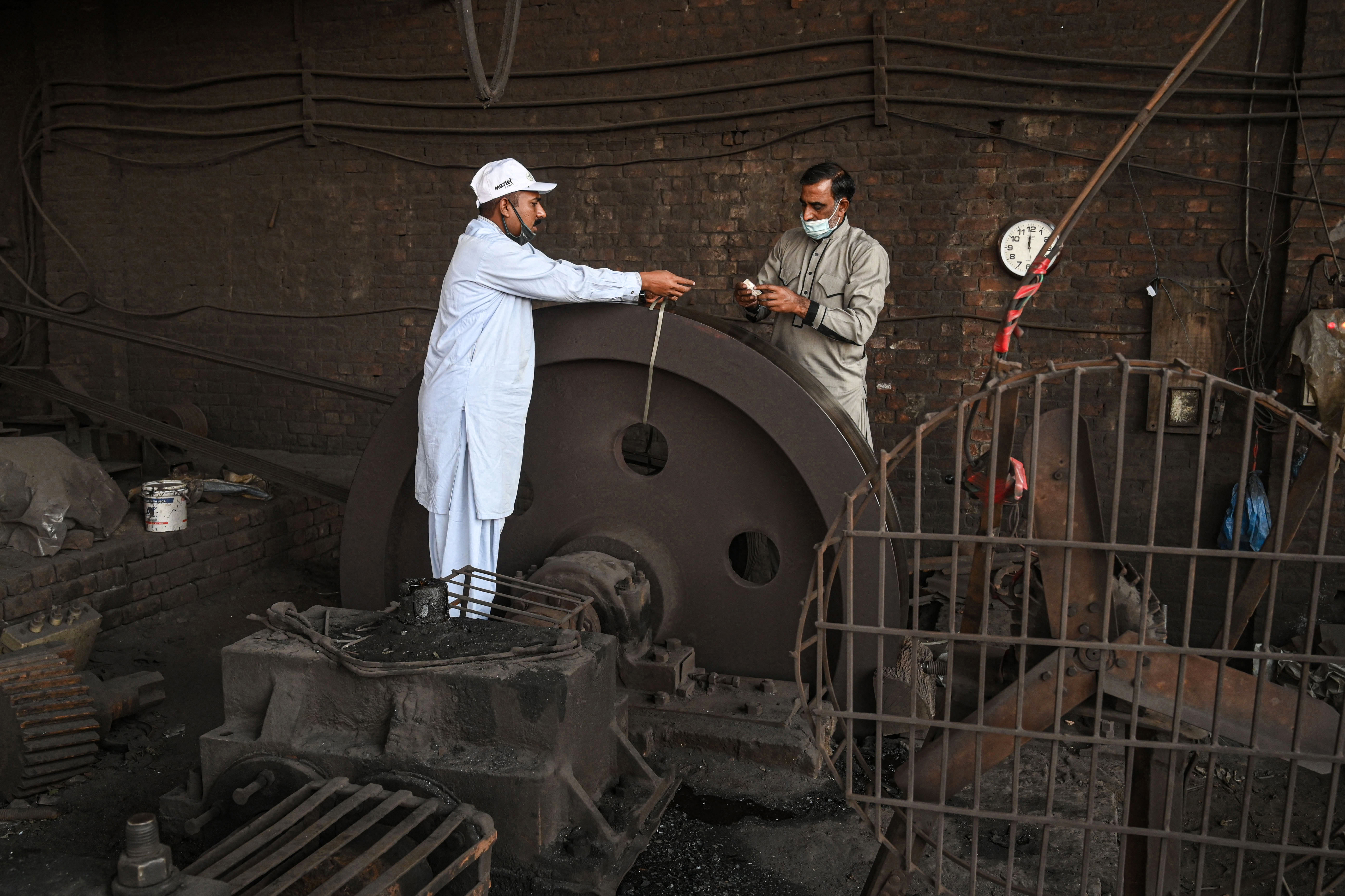 Officials of the environment department’s Anti-Smog Squad preparing to seal a steel factory for violating pollution norms in Lahore