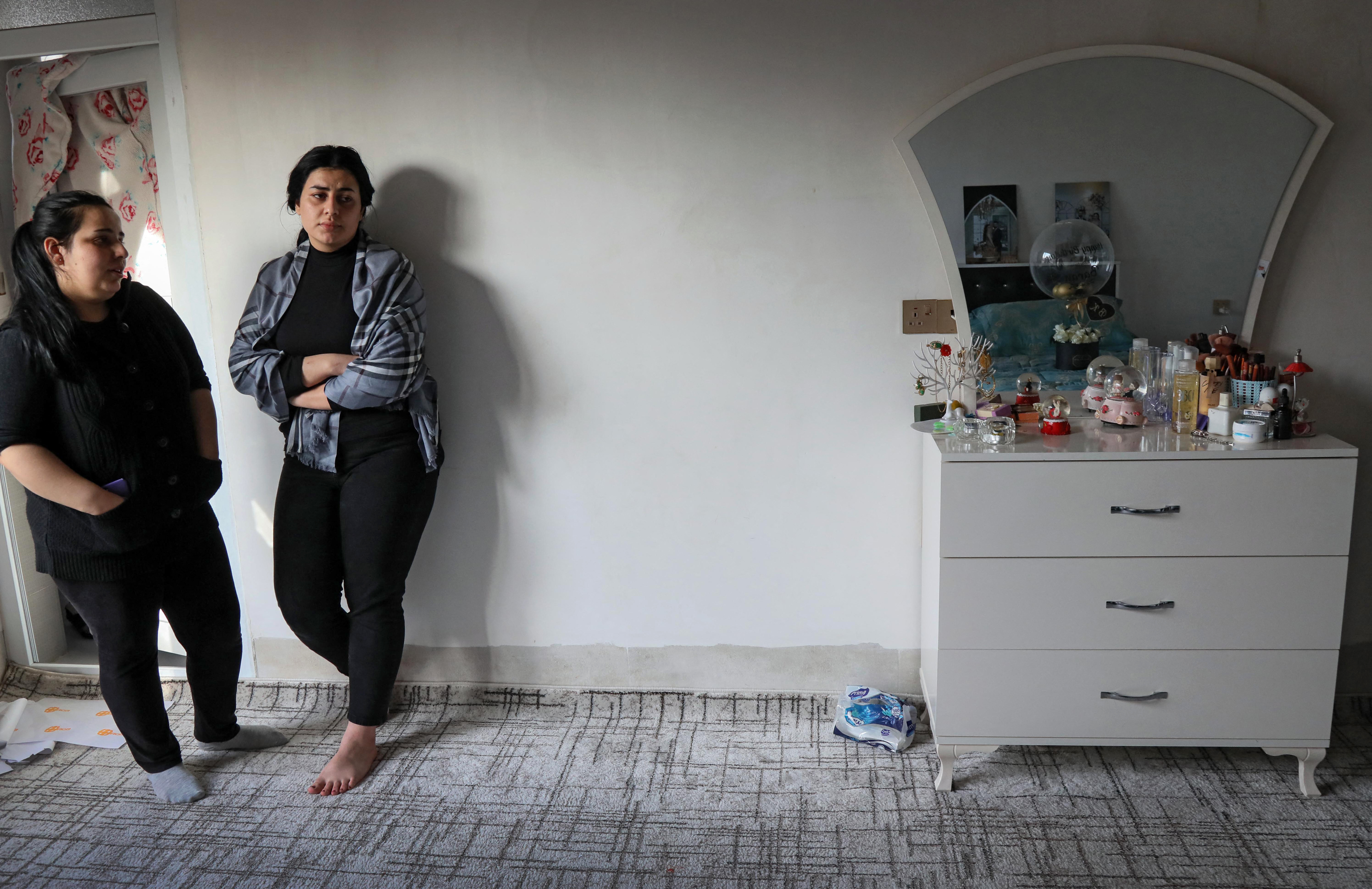 Women stand in the bedroom of Iraqi Kurd Maryam Nuri Hama Amin