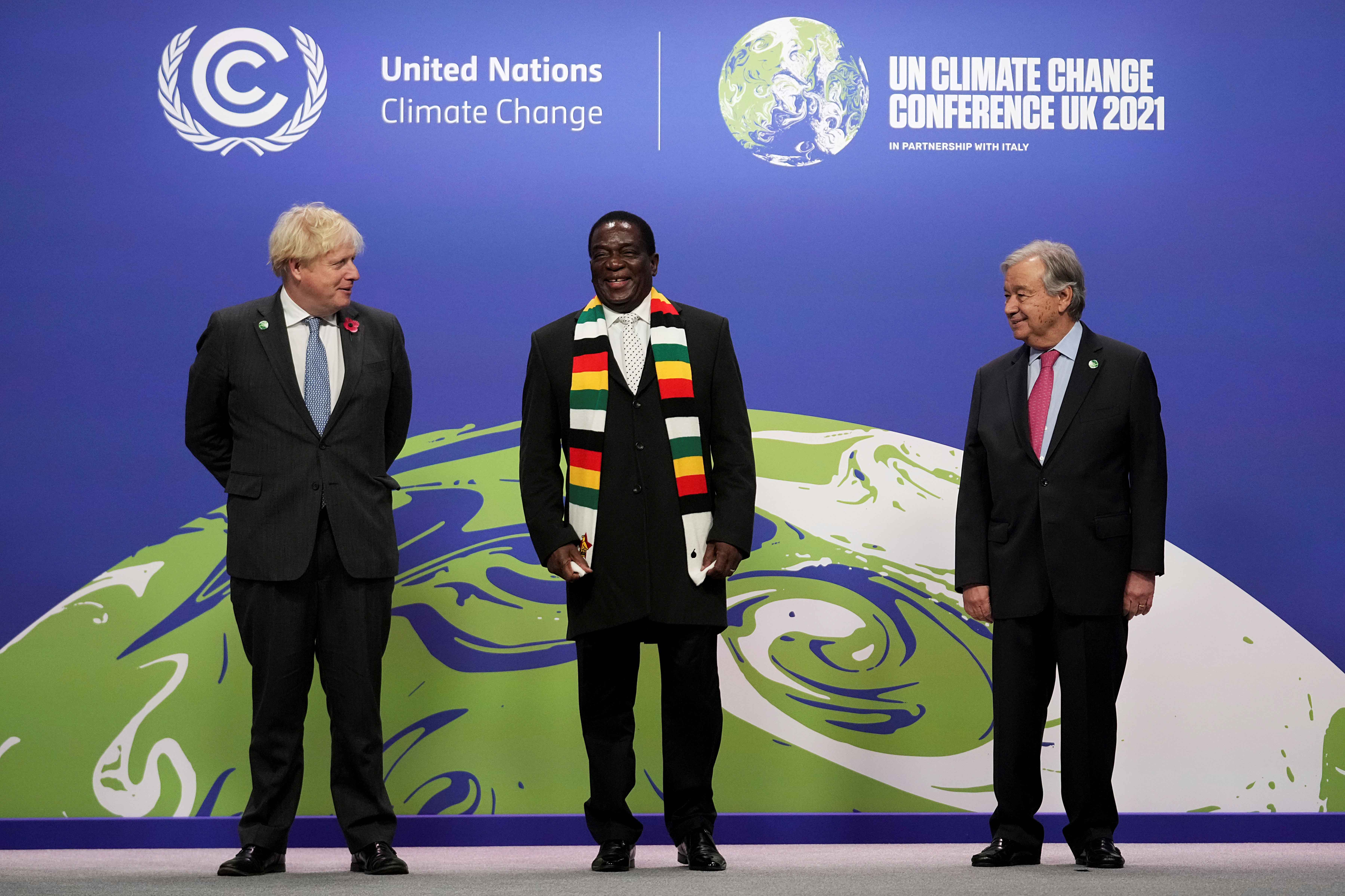 Zimbabwe's President Emmerson Mnangagwa, centre, poses with UN Secretary-General Antonio Guterres, right, and British Prime Minister Boris Johnson as he arrives for the COP26 on November 1 [Reuters/Christopher Furlong]