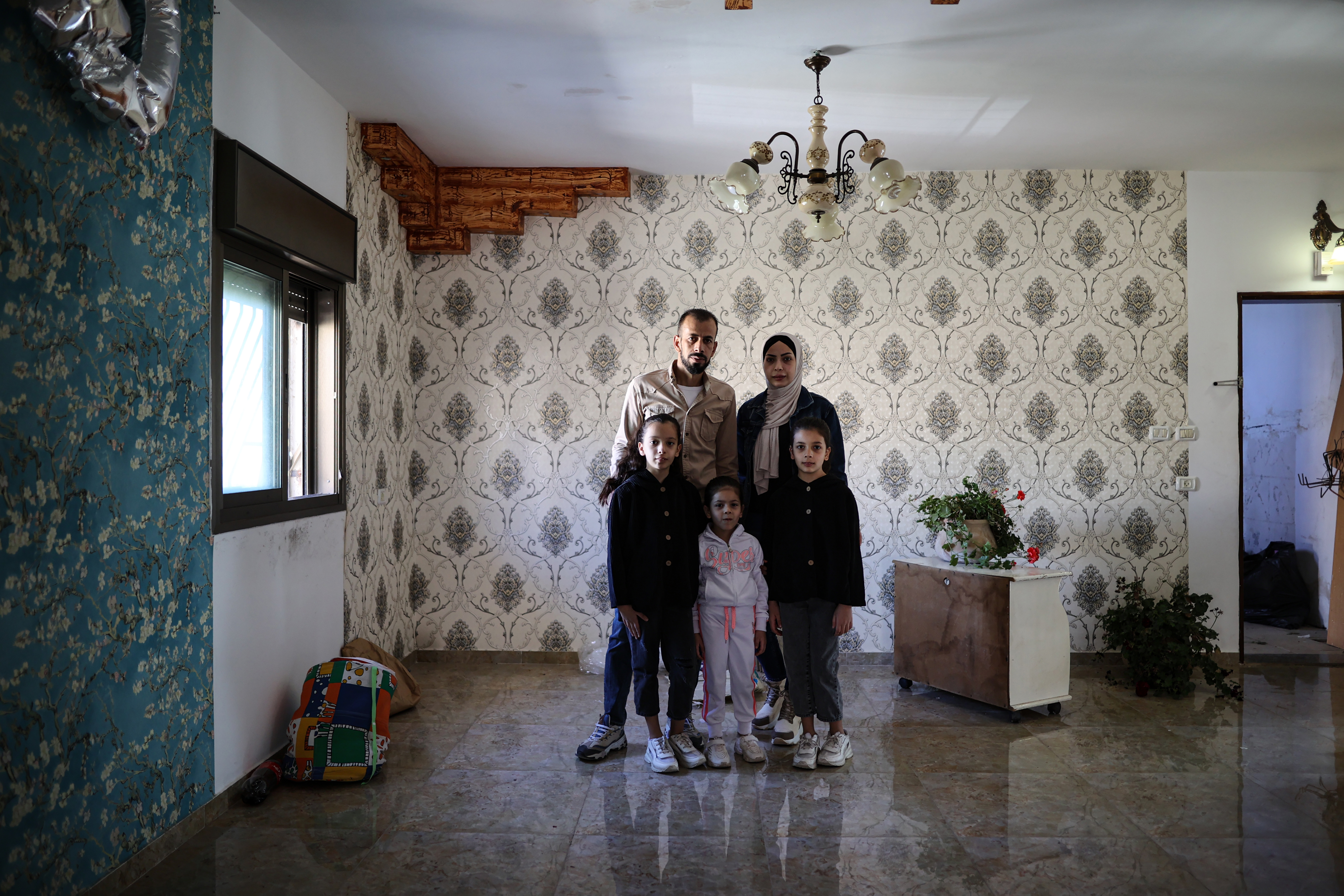 Myassar Abu Halaweh with her husband and three daughters, Mariam, 5, Julia, 9, and Elya, 10 [Al Jazeera]
