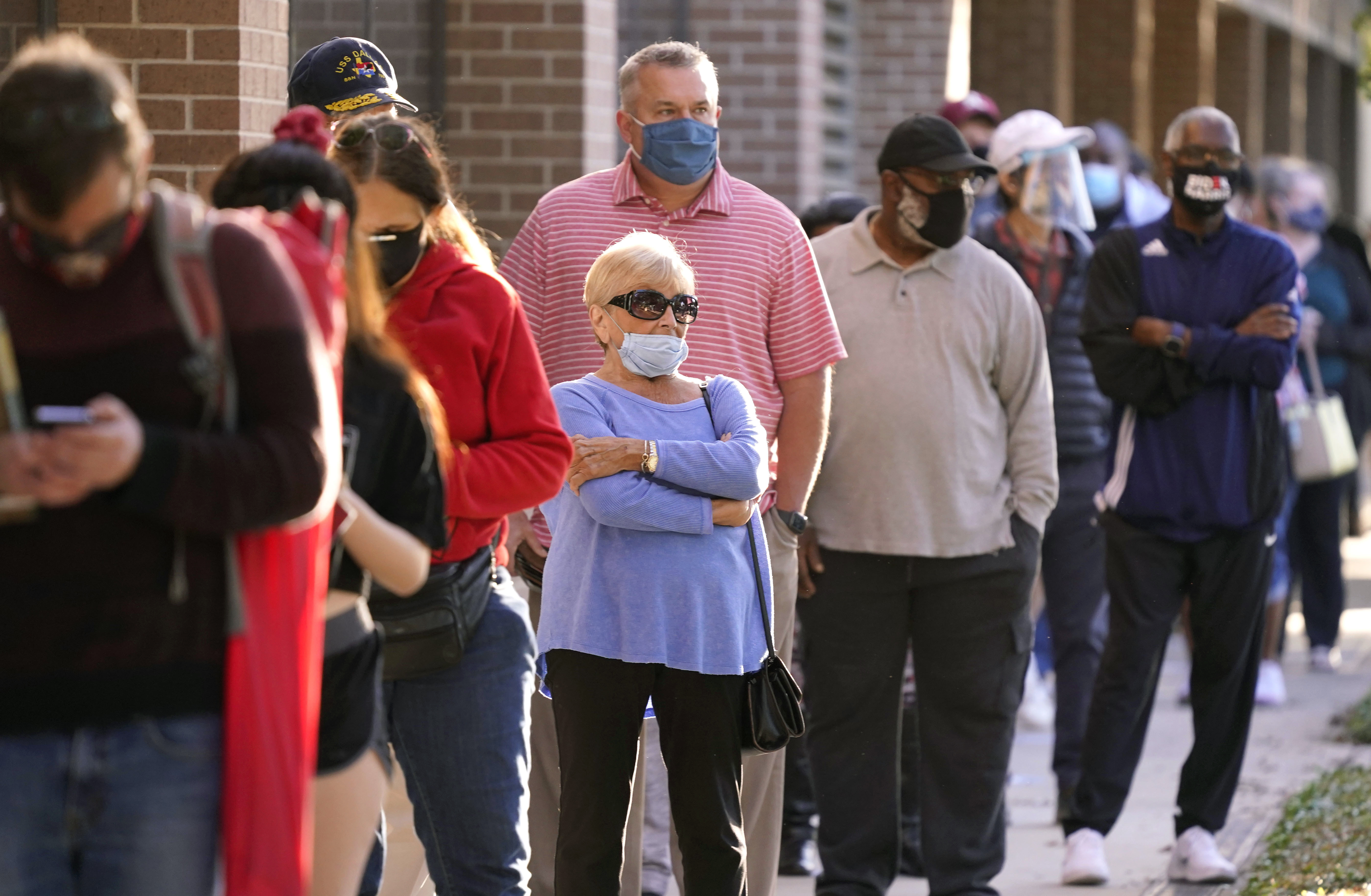 Voters line up outside Richardson City Hall for early voting on Tuesday, October 13, 2020, in Richardson, Texas, US