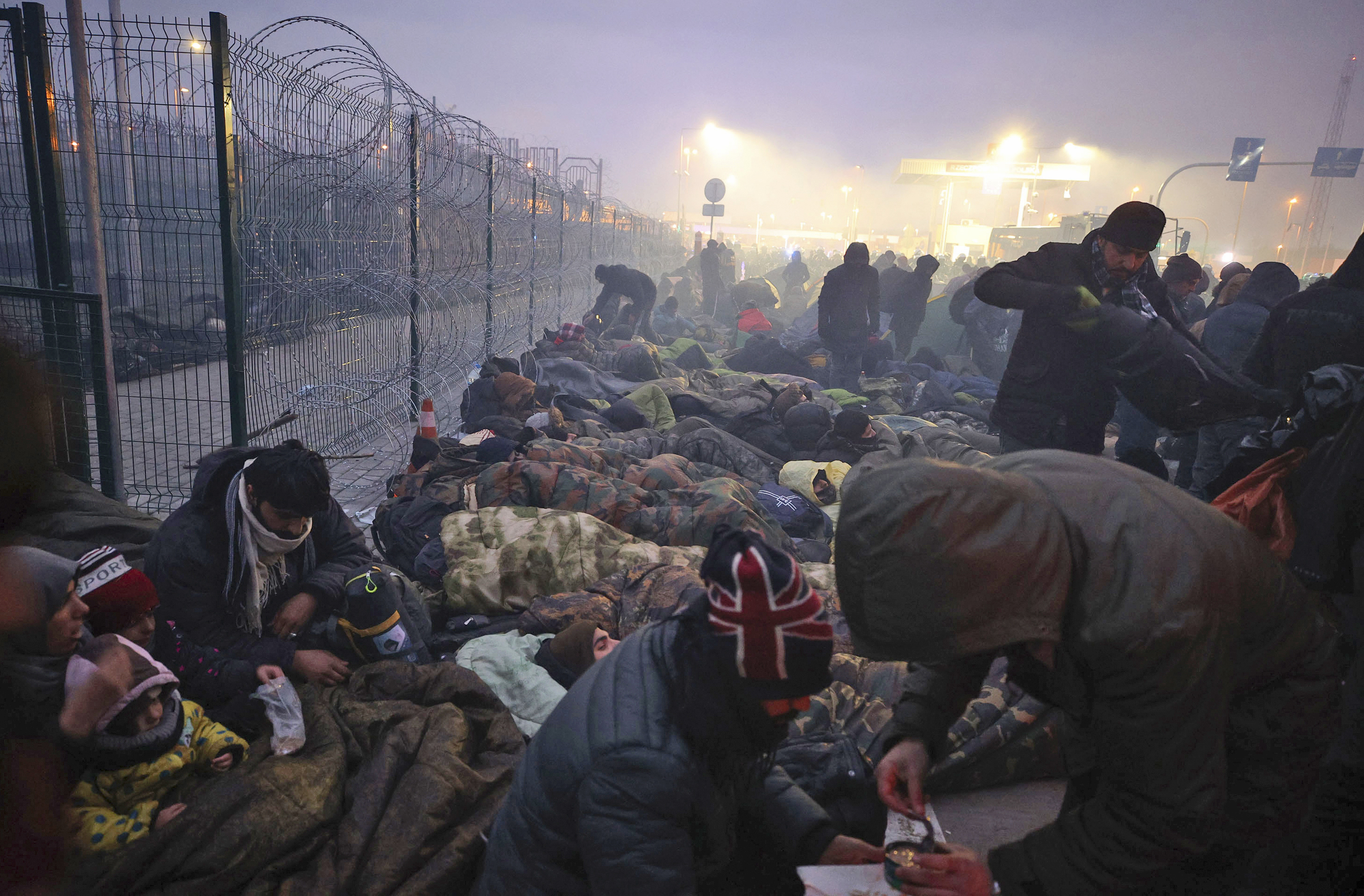 Refugees and migrants gathered last year at Kuznitsa on the Belarus-Poland border