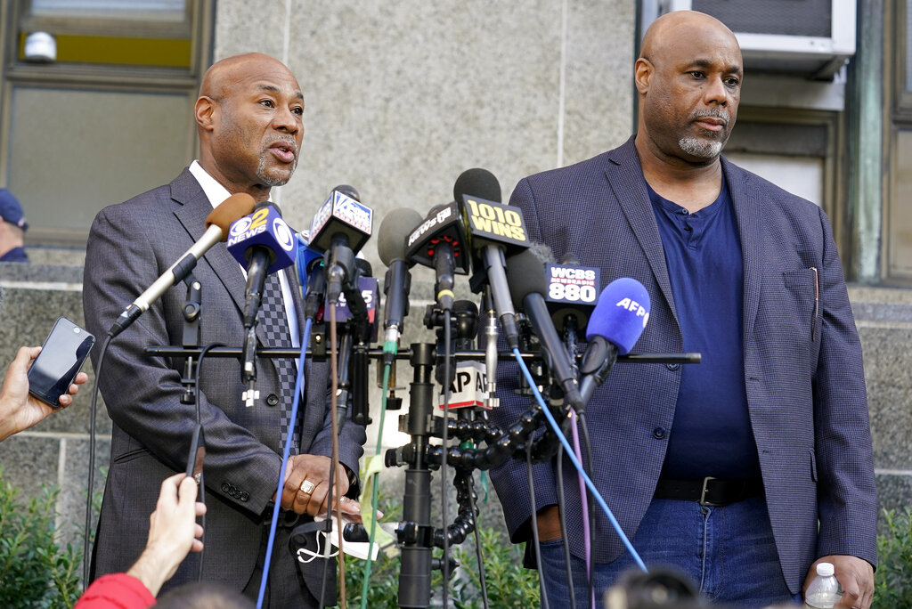 Ameen Johnson, left, and Shahid Johnson, sons of Khalil Islam, whose conviction of killing Malcolm X was tossed out by a judge, speak during a press conference on Thursday
