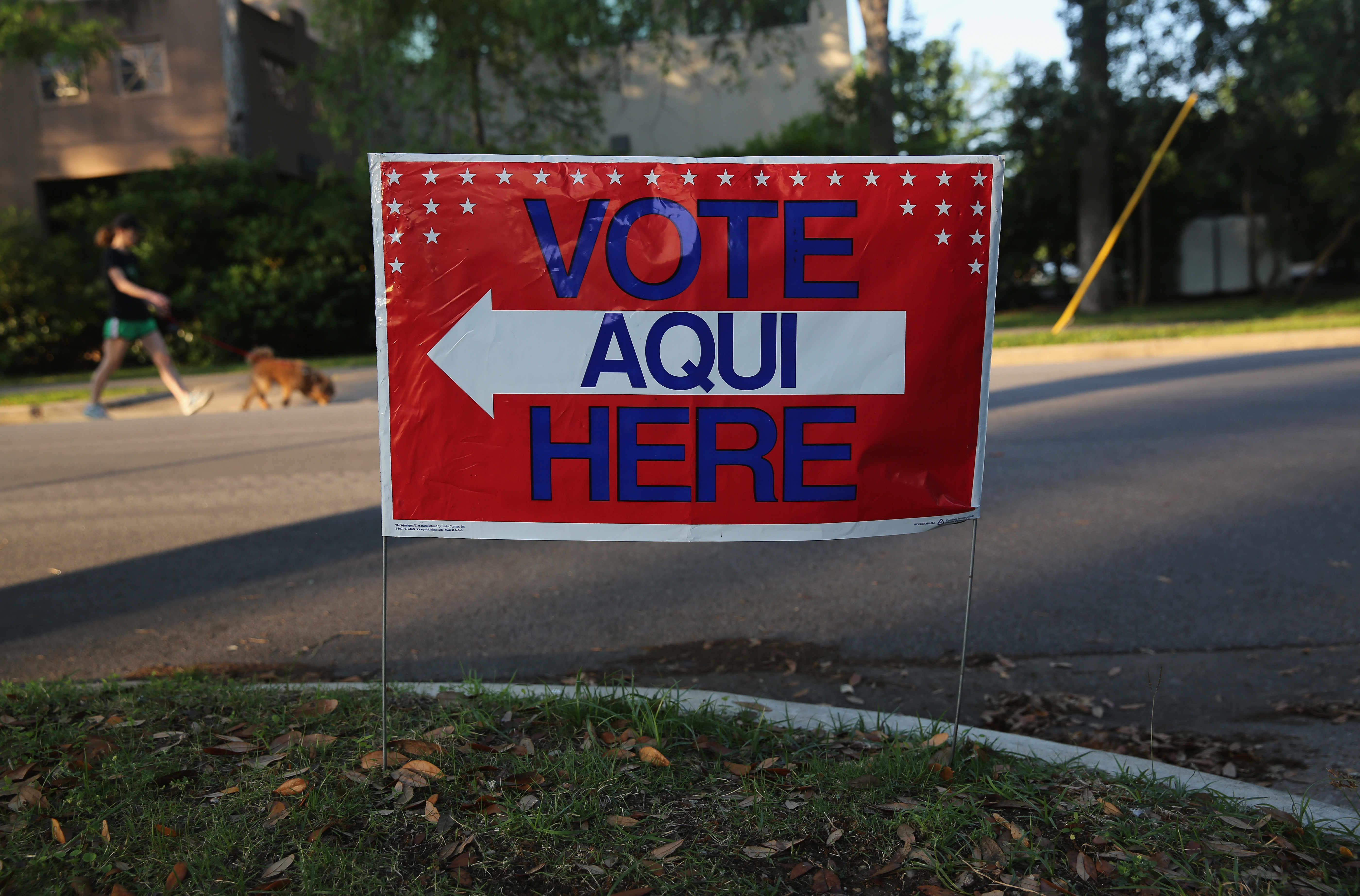 A bilingual sign stands outside a polling centre at a public library ahead of local elections on April 28, 2013 in Texas, where the Hispanic community has grown in the past decade