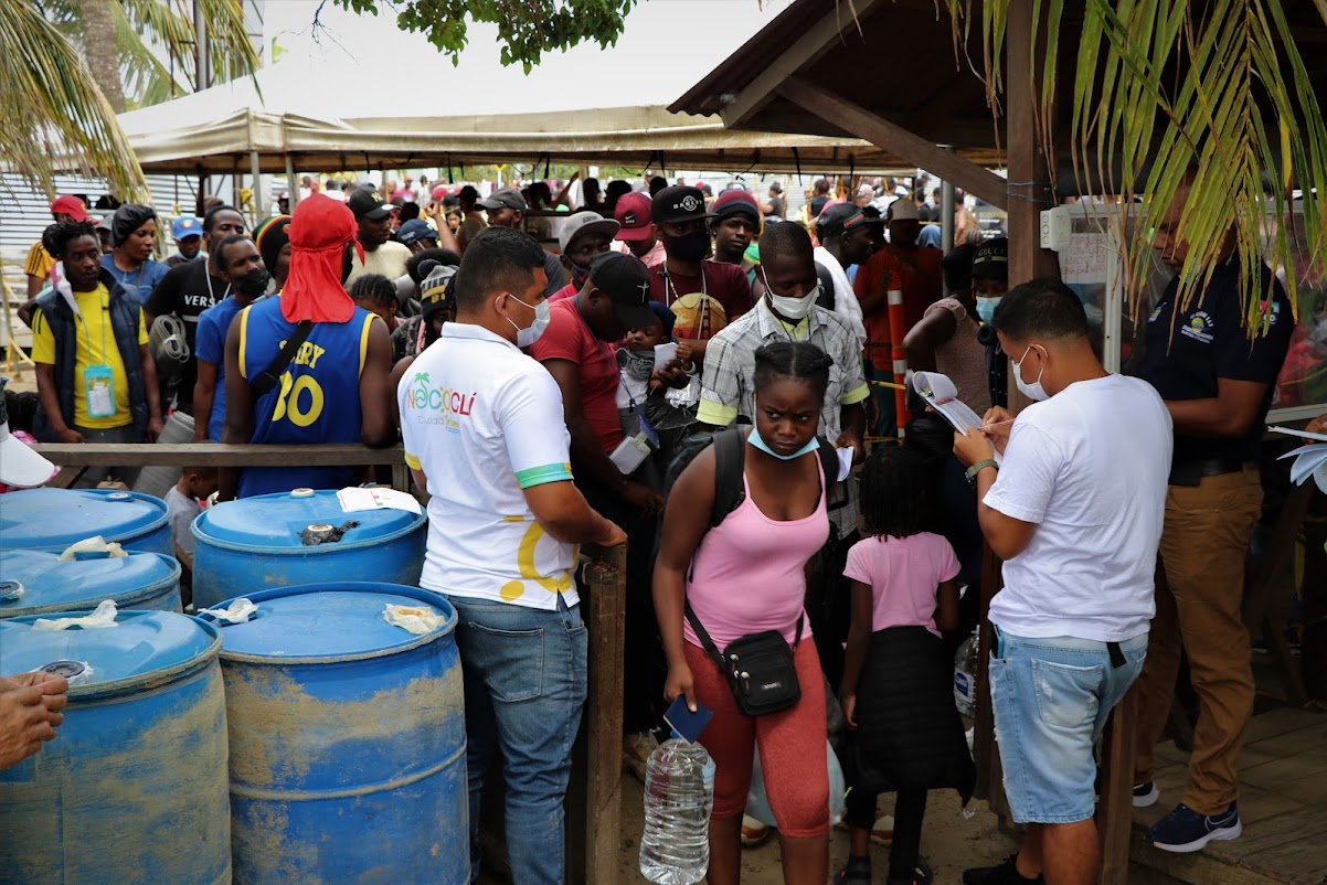 Port officials in Neecoclí scramble to get people, who paid for tickets weeks in advance, onto boats to take them across the Gulf of Uraba