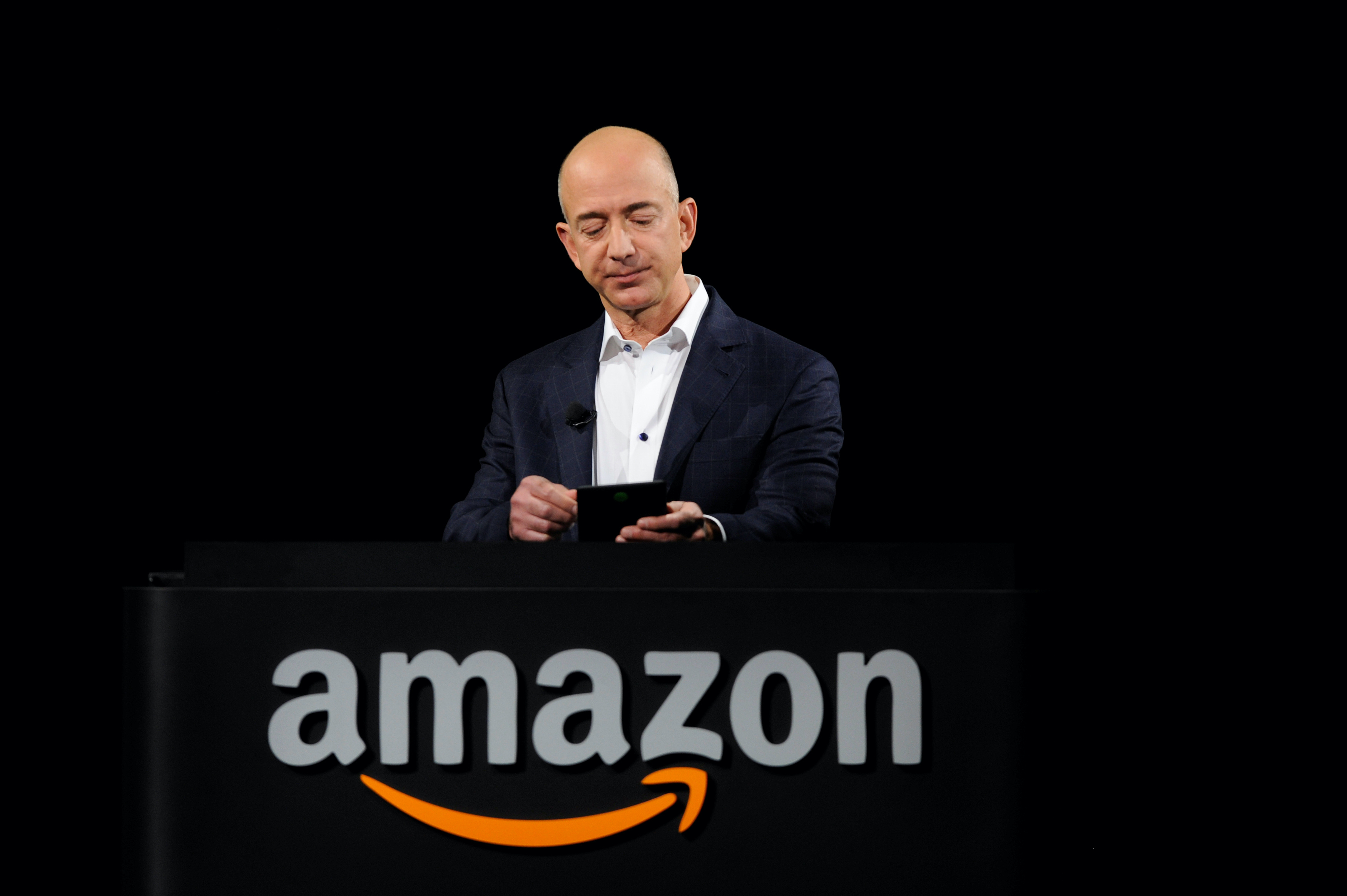 Amazon founder Jeff Bezos demonstrates the Kindle during an Amazon event in California, US