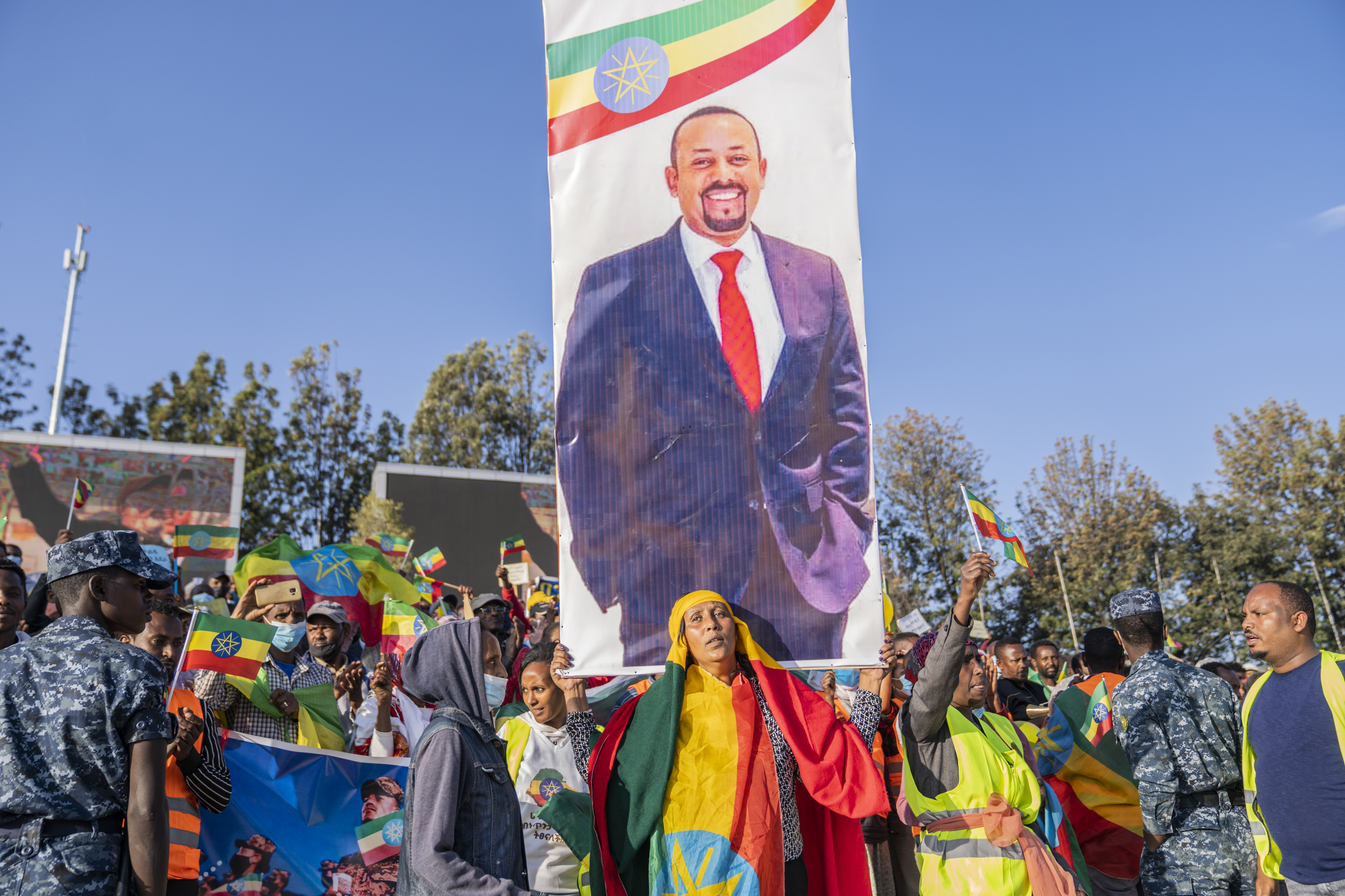 Ethiopians carry a poster of Abiy Ahmed as they attend a rally held to show support for the government and the Ethiopian forces, in their efforts against the TPLF and OLA, in Addis Ababa, on November 7, 2021 [EPA]