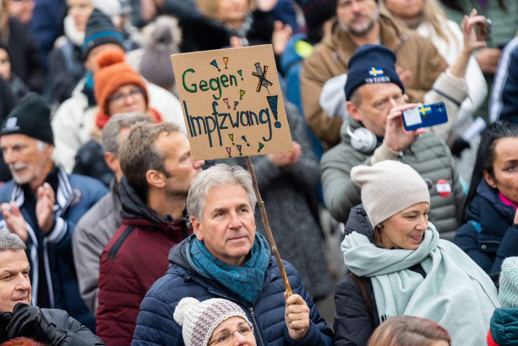 A demonstrator holds a placard reading ‘Against compulsory vaccination’ during an anti-vaccination protest at the Ballhausplatz in Vienna, Austria