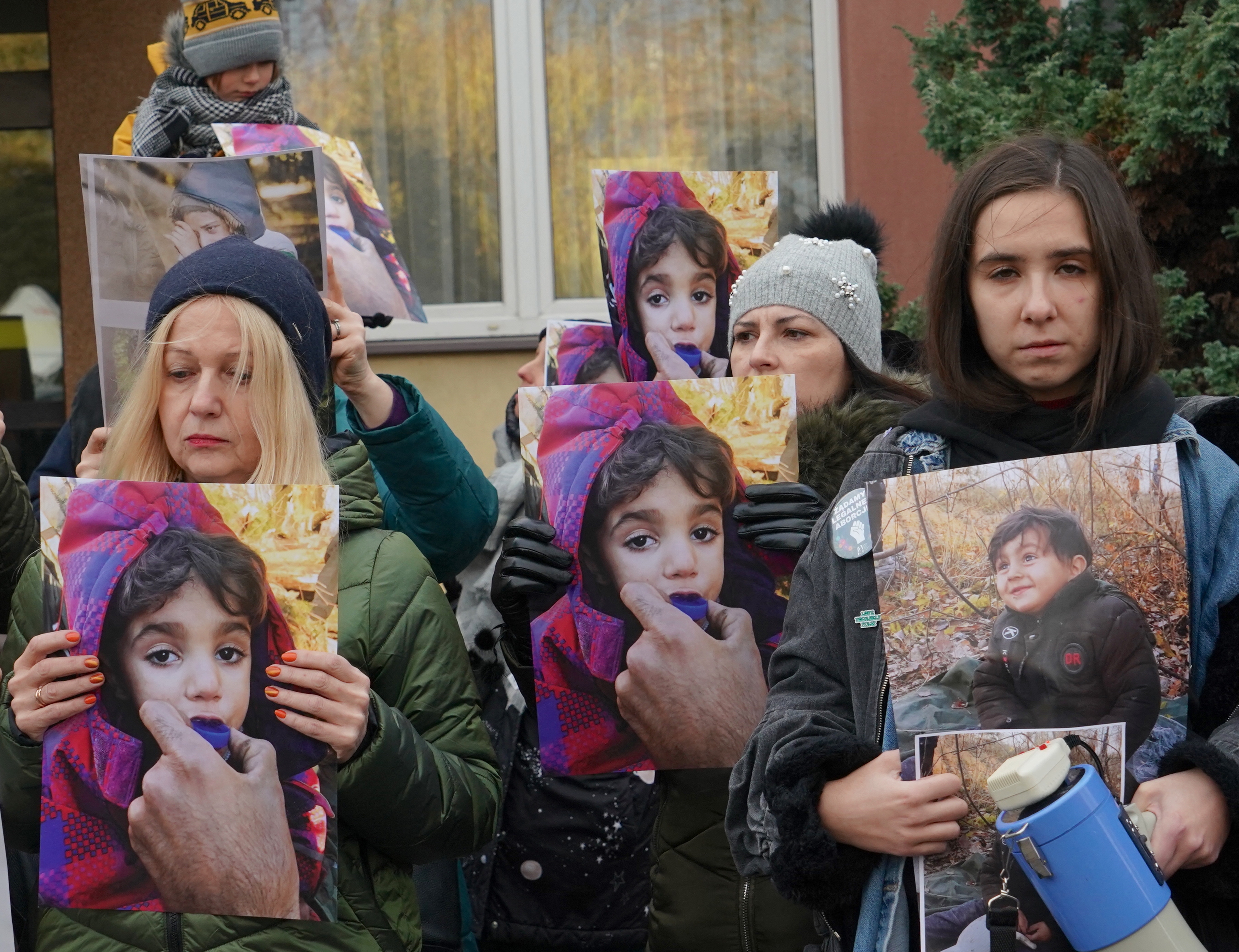 People protest with photos of children to draw attention to the humanitarian situation on the Polish-Belarusian border