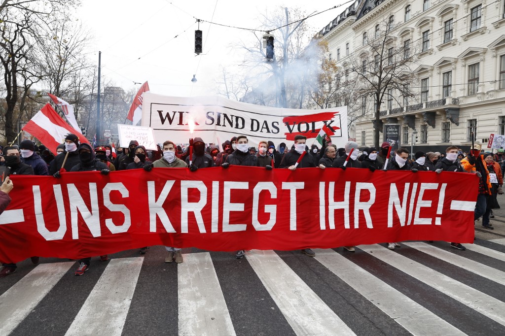 Protesters hold a banner reading, ‘You will never get us’ during a demonstration in Vienna [AFP]