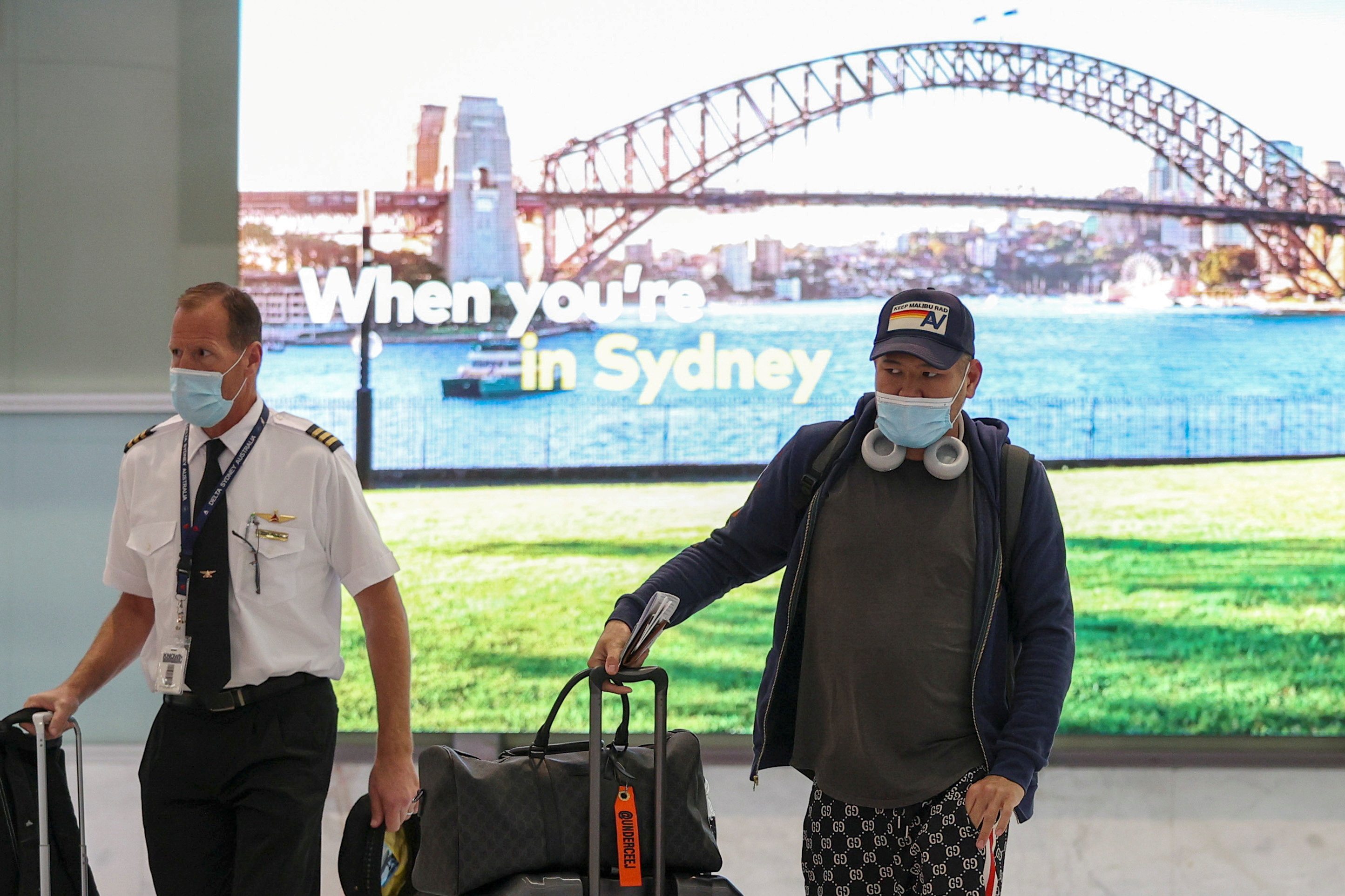 Travellers and flight crew members arrive at the international terminal at Sydney Airport, as countries react to the new coronavirus Omicron variant
