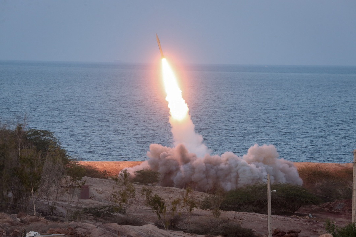 Flash of a missile being launched with the sea in the background