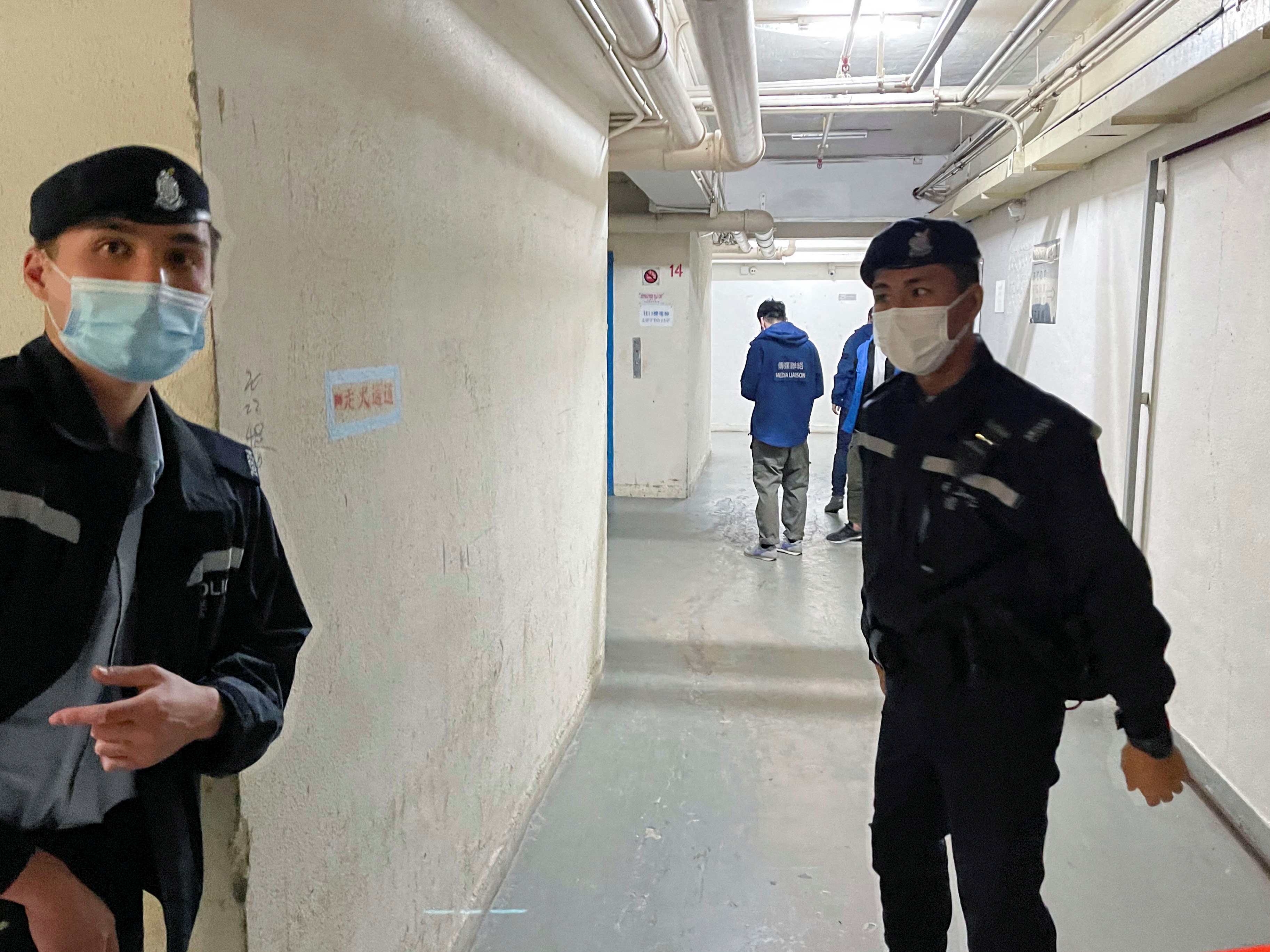 Police stand guard outside the Stand News office after six people were arrested ‘for conspiracy to publish seditious publication’, according to Hong Kong’s Police National Security Department