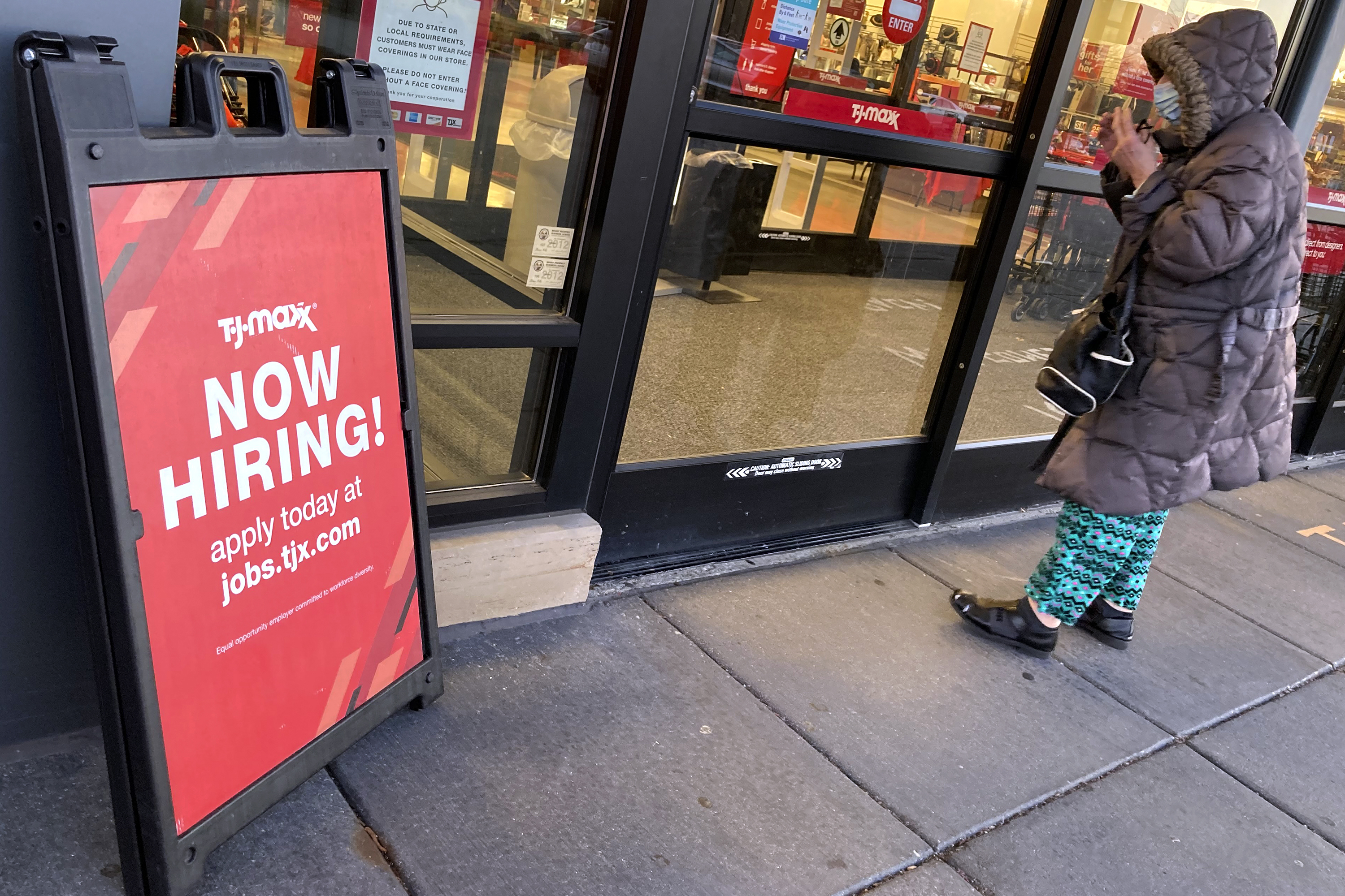 A hiring sign is seen outside of a retail store in Mount Prospect, Ill.
