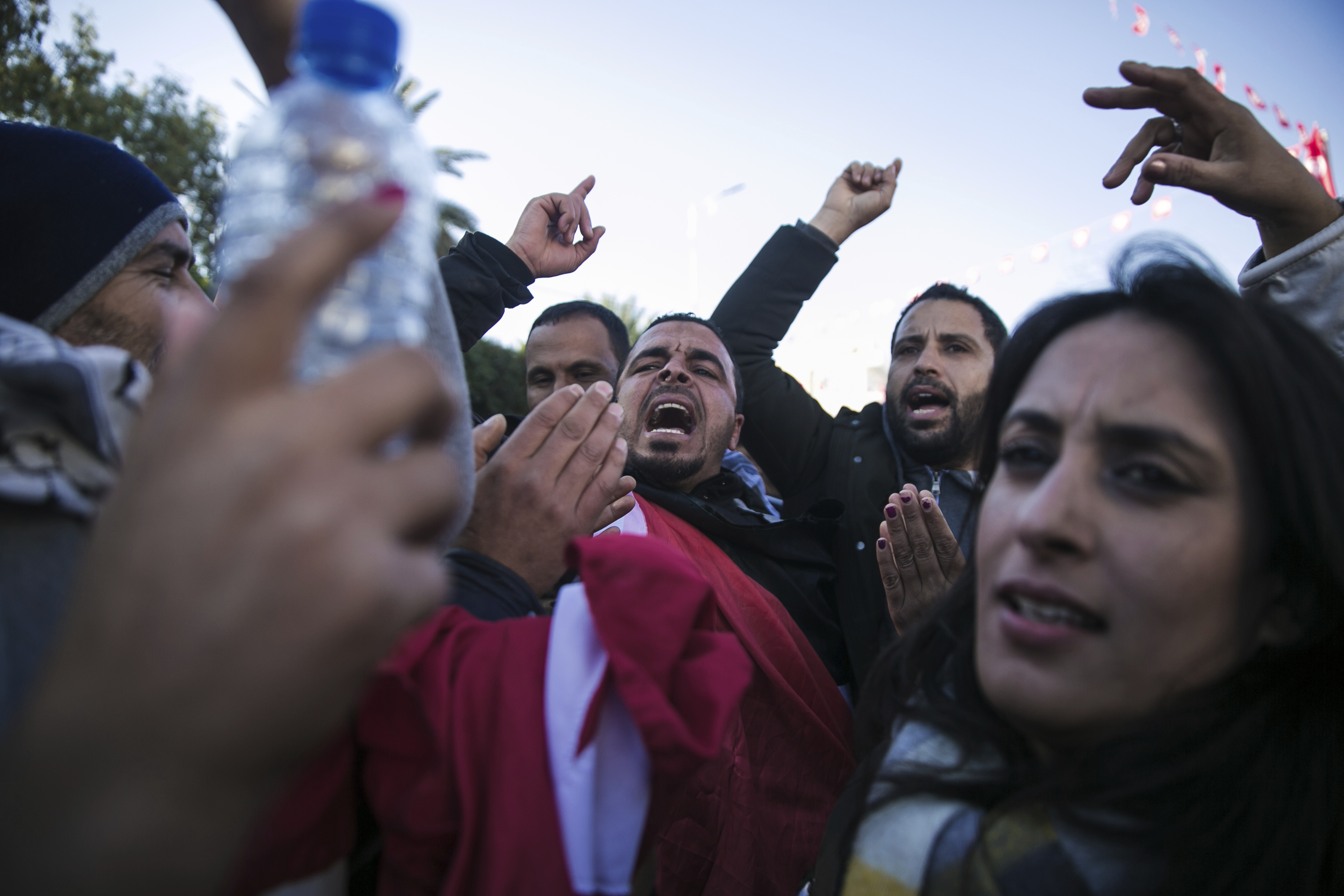 Unemployed Tunisian graduates shout slogans as they attend a protest on the anniversary of the Tunisian revolution, in Sidi Bouzid, Tunisia